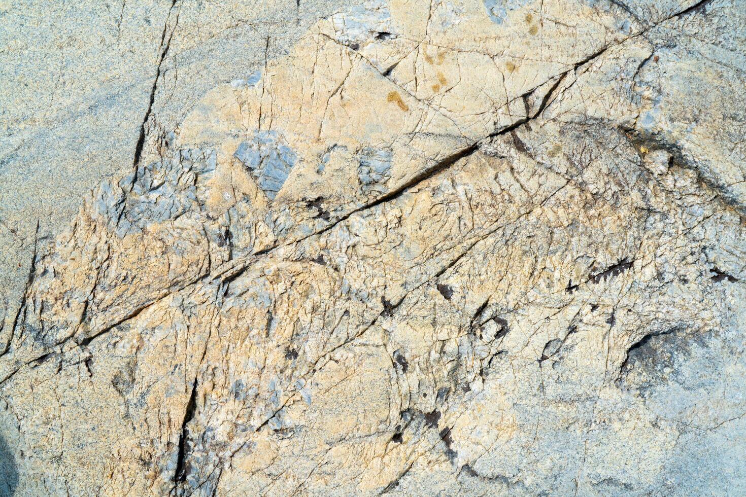 Cracked stone surface. The texture of granite. photo