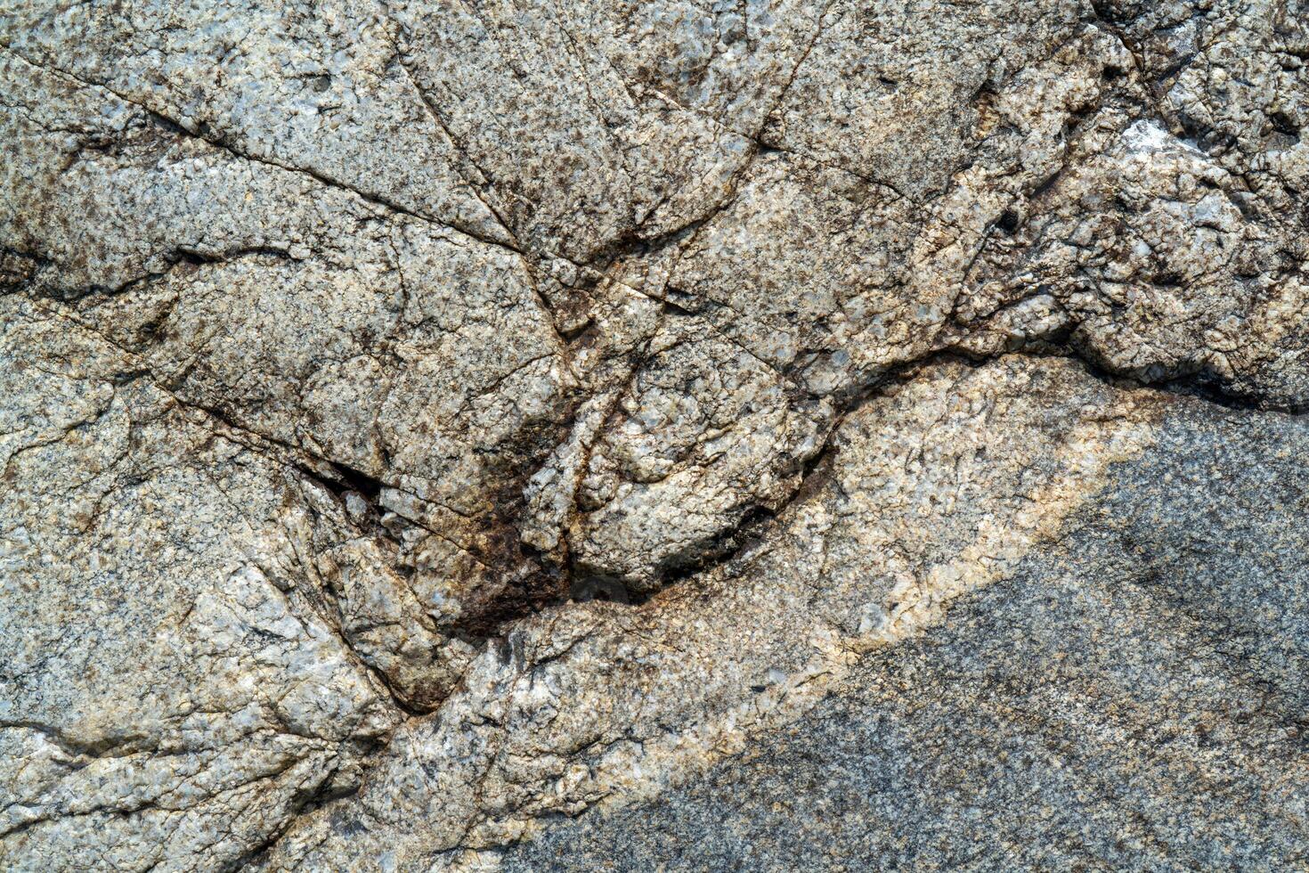 Cracked stone surface. The texture of granite. photo
