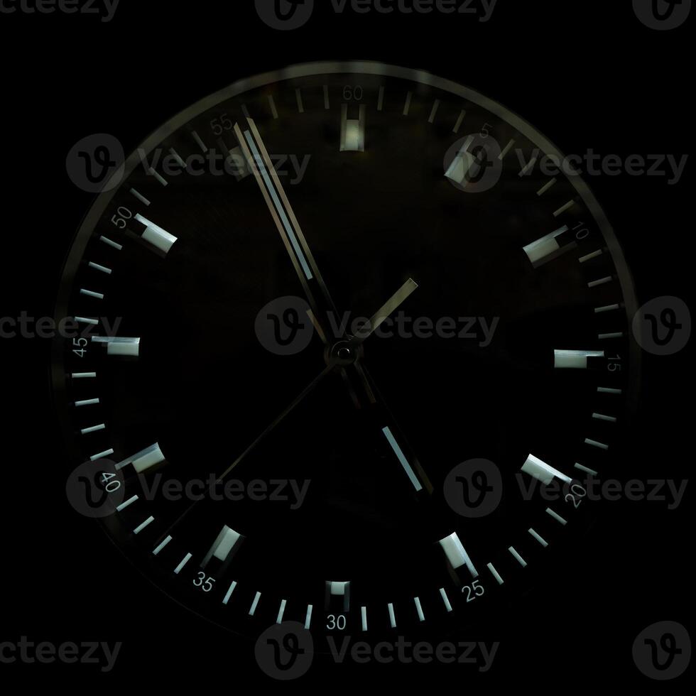 The watch dial is black. Shiny clock hands. photo