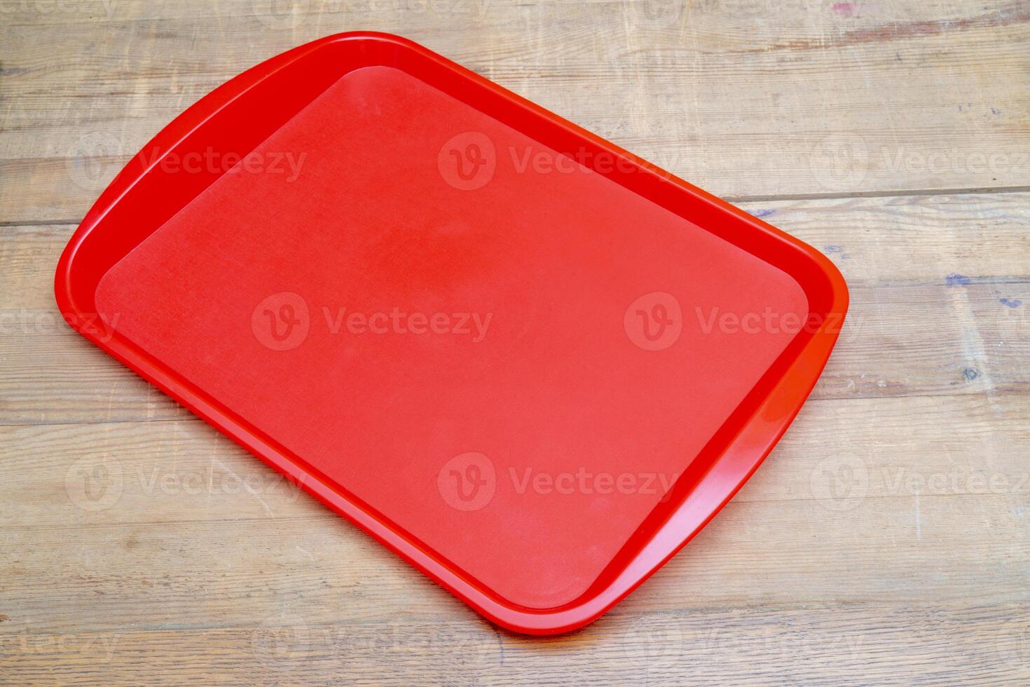 Red plastic dining tray on the table. photo
