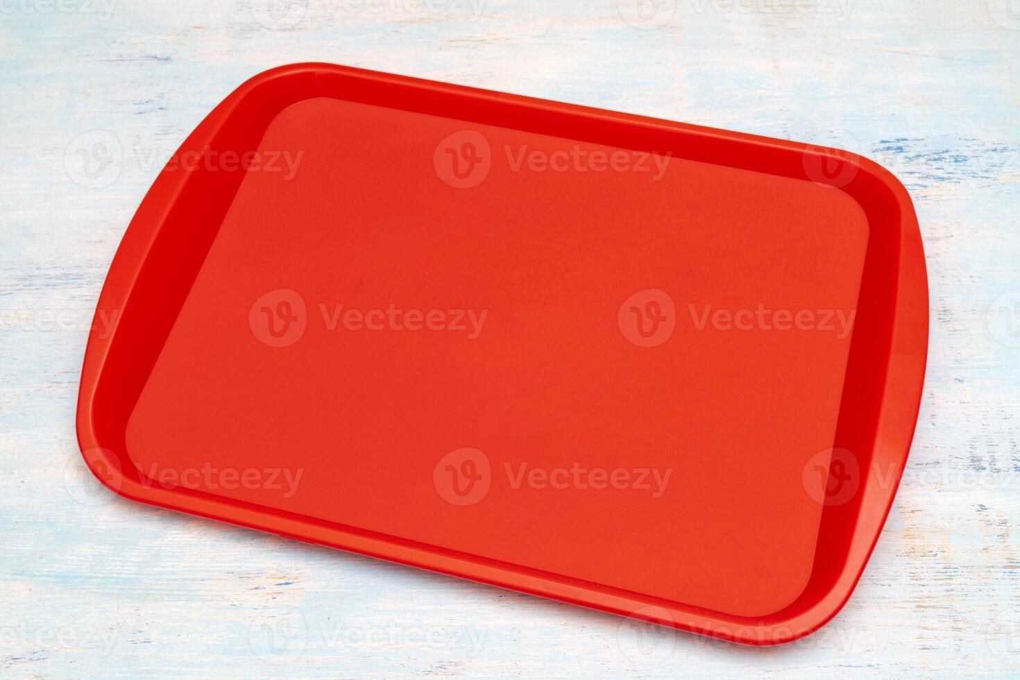 Red plastic dining tray on the table. photo