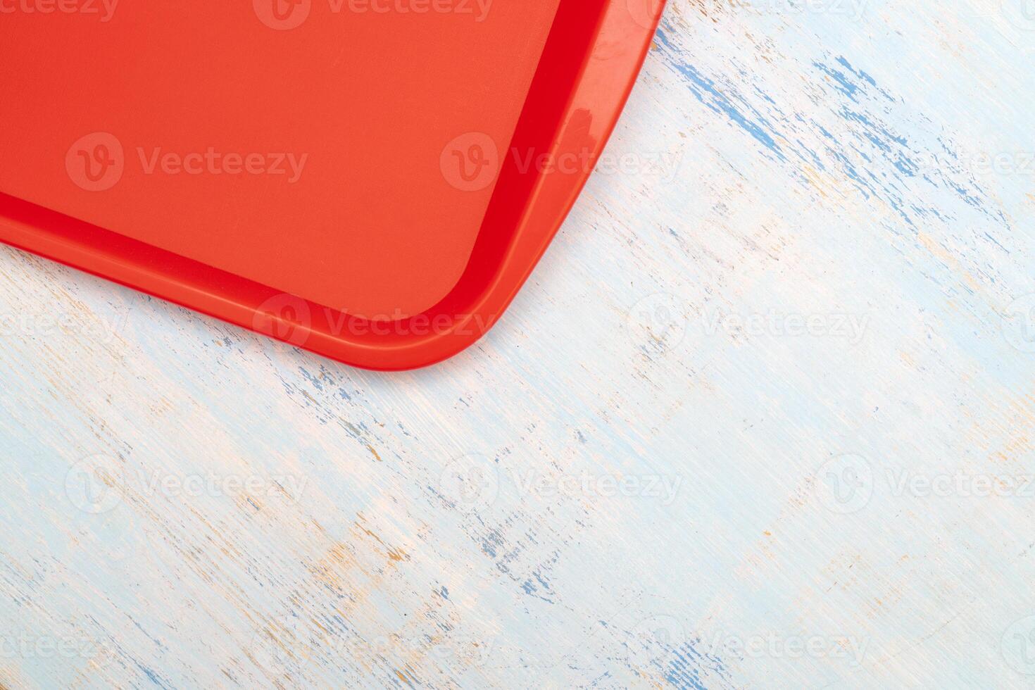 Red plastic dining tray on the table. photo