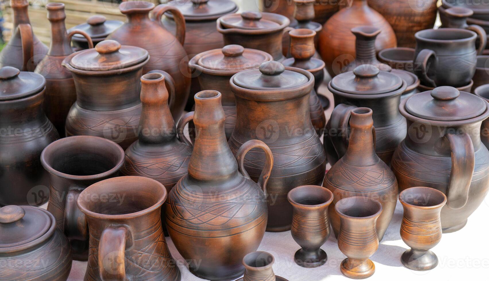 Handmade ceramic clay products. Jugs and glasses. photo