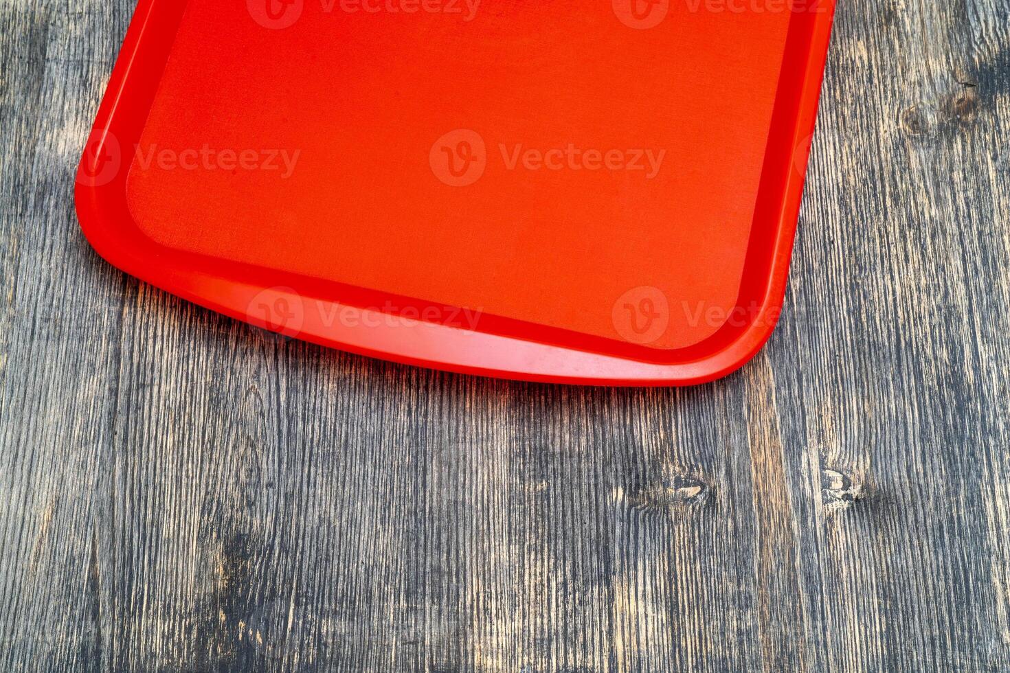 Red plastic dining tray on the table. photo