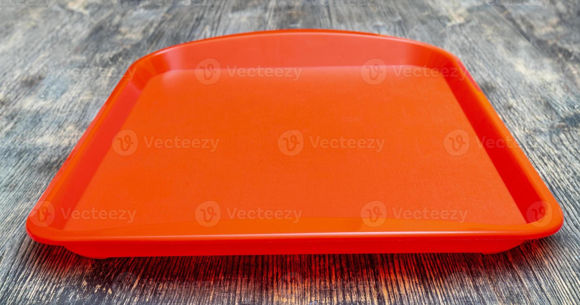 Red plastic dining tray on the table. photo