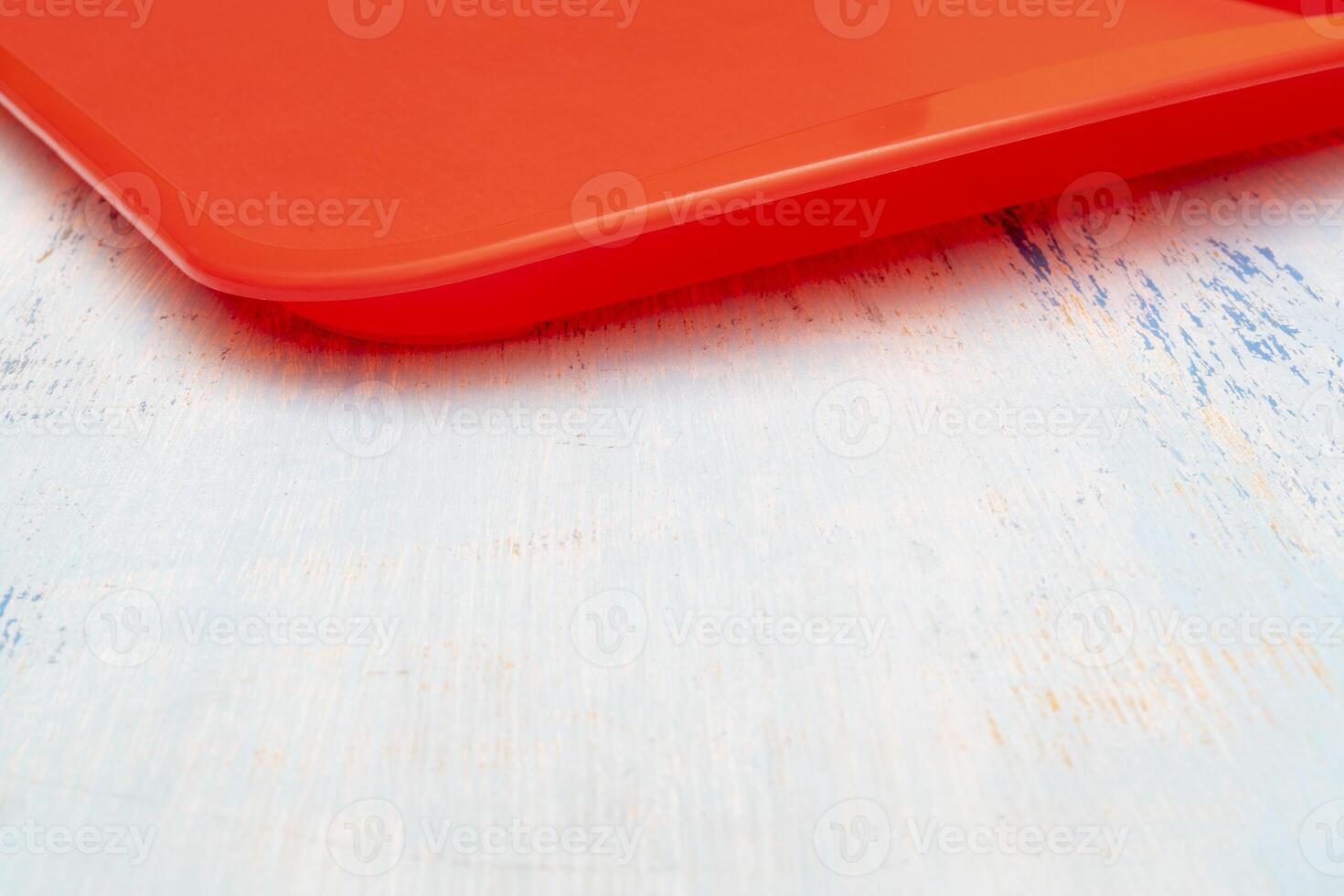 Red plastic dining tray on the table. photo