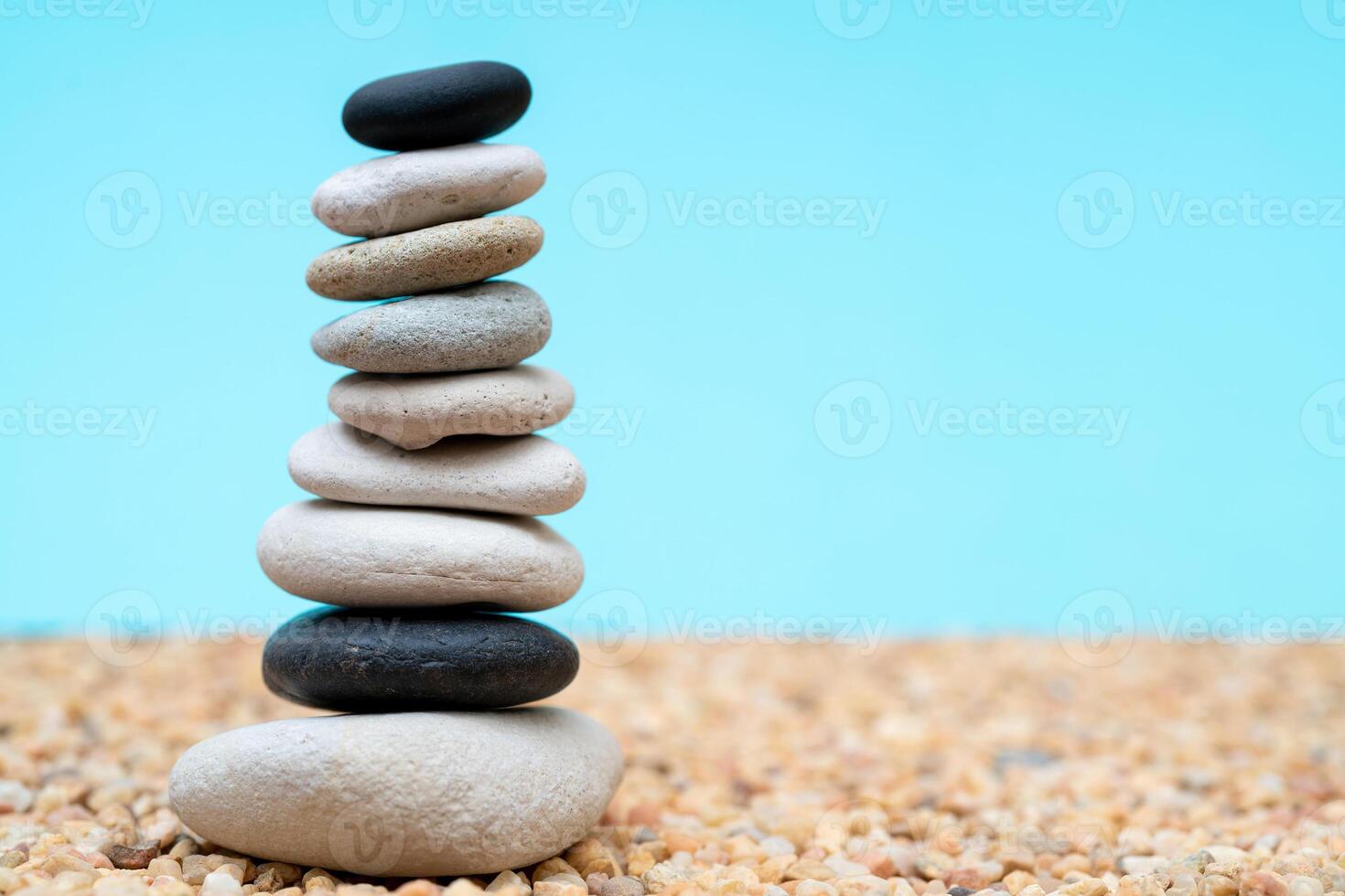 Stack of pebbles in an unstable state. A pyramid made of flat stones. photo
