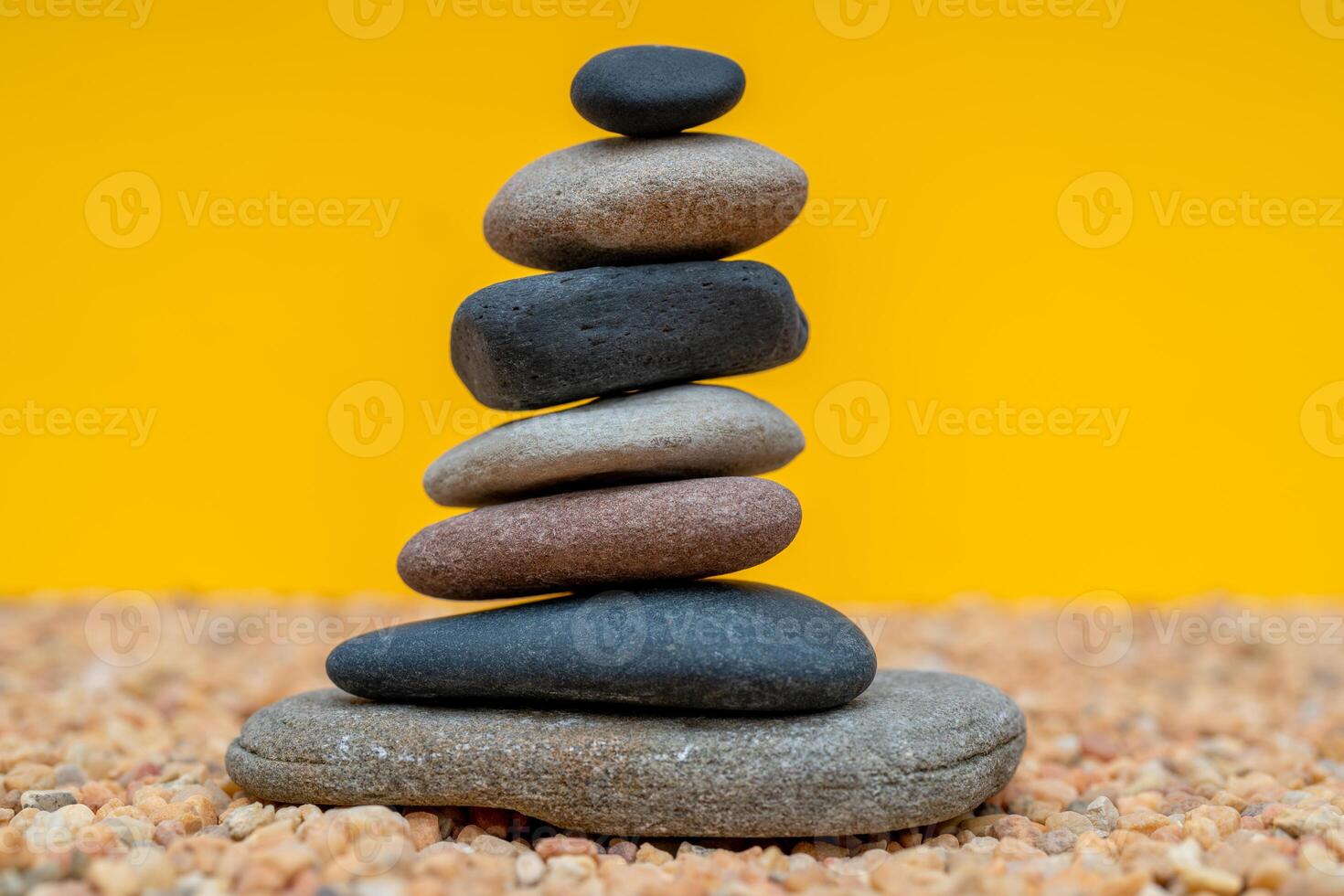 Stack of pebbles in an unstable state. A pyramid made of flat stones. photo