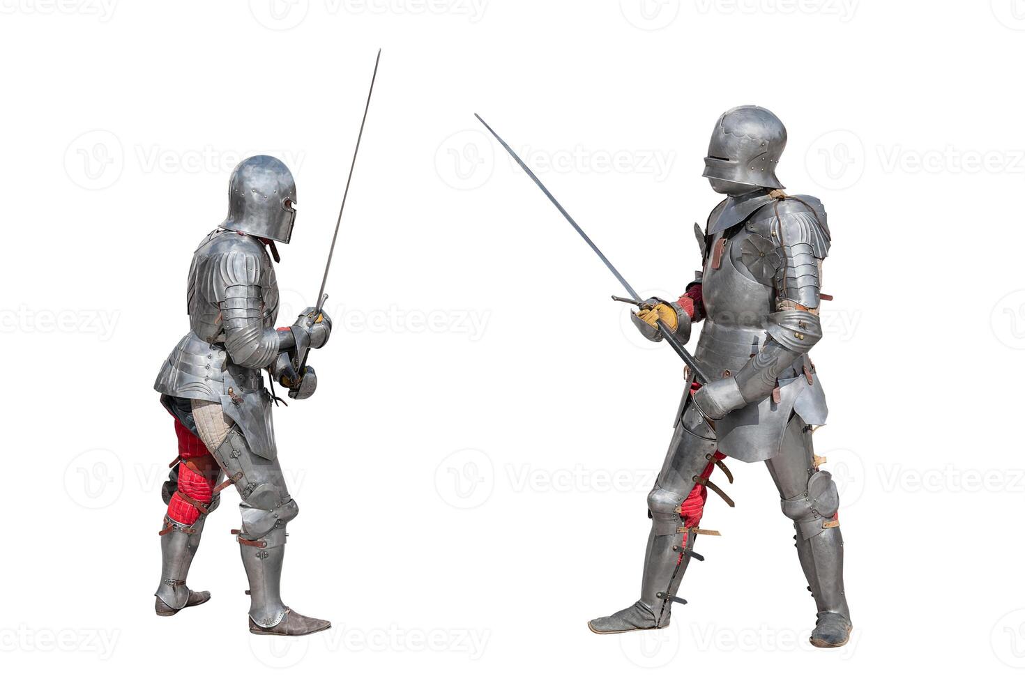 Knights in armor. Medieval knights in iron armor hold swords in their hands. Duel of the medieval warriors. The battle of two knights on swords. photo