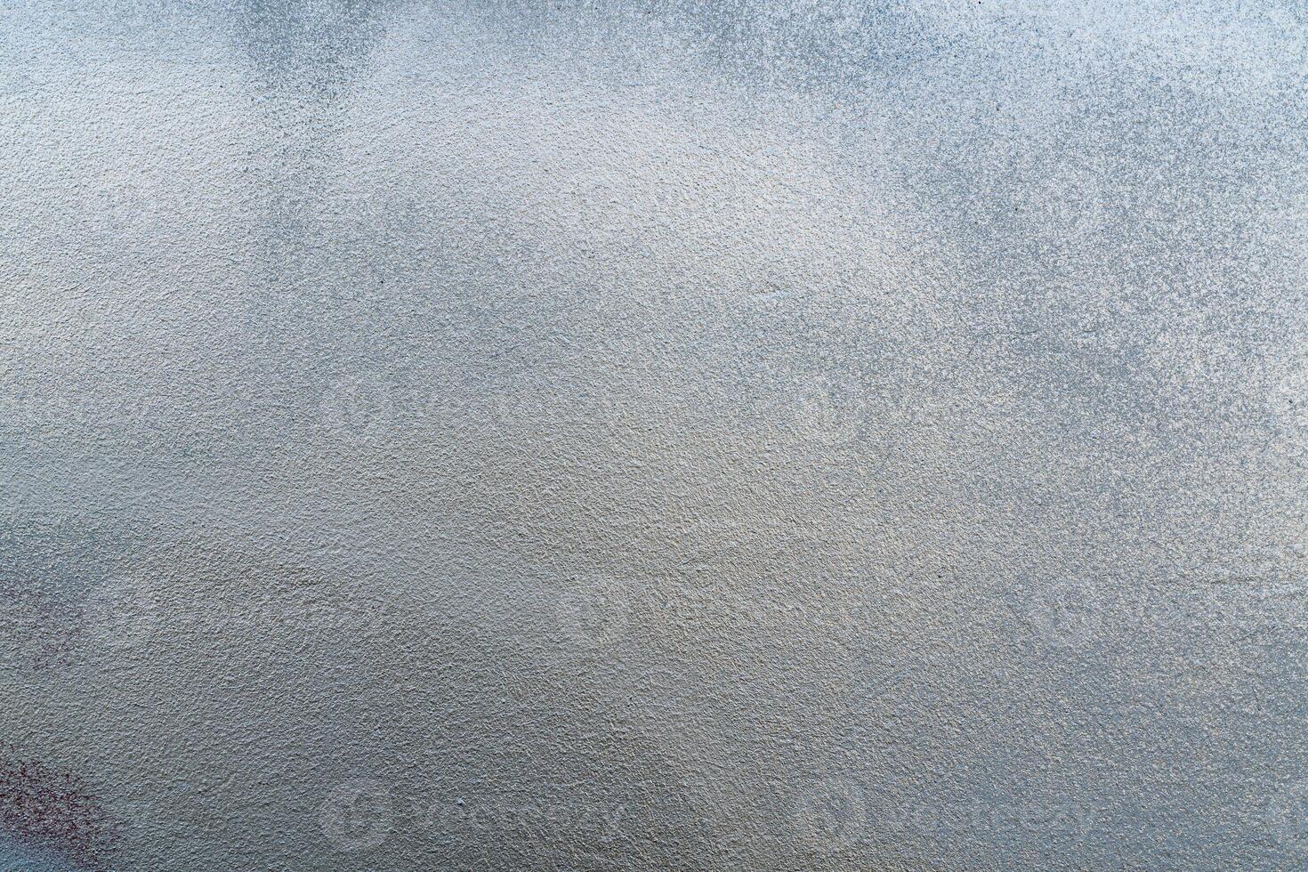 Silver paint on a rough wall. Abstract gray background. photo