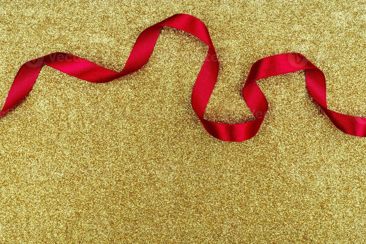 Red wavy ribbon on gold background. Holiday decoration. Valentine's Day decoration congratulation frame. photo