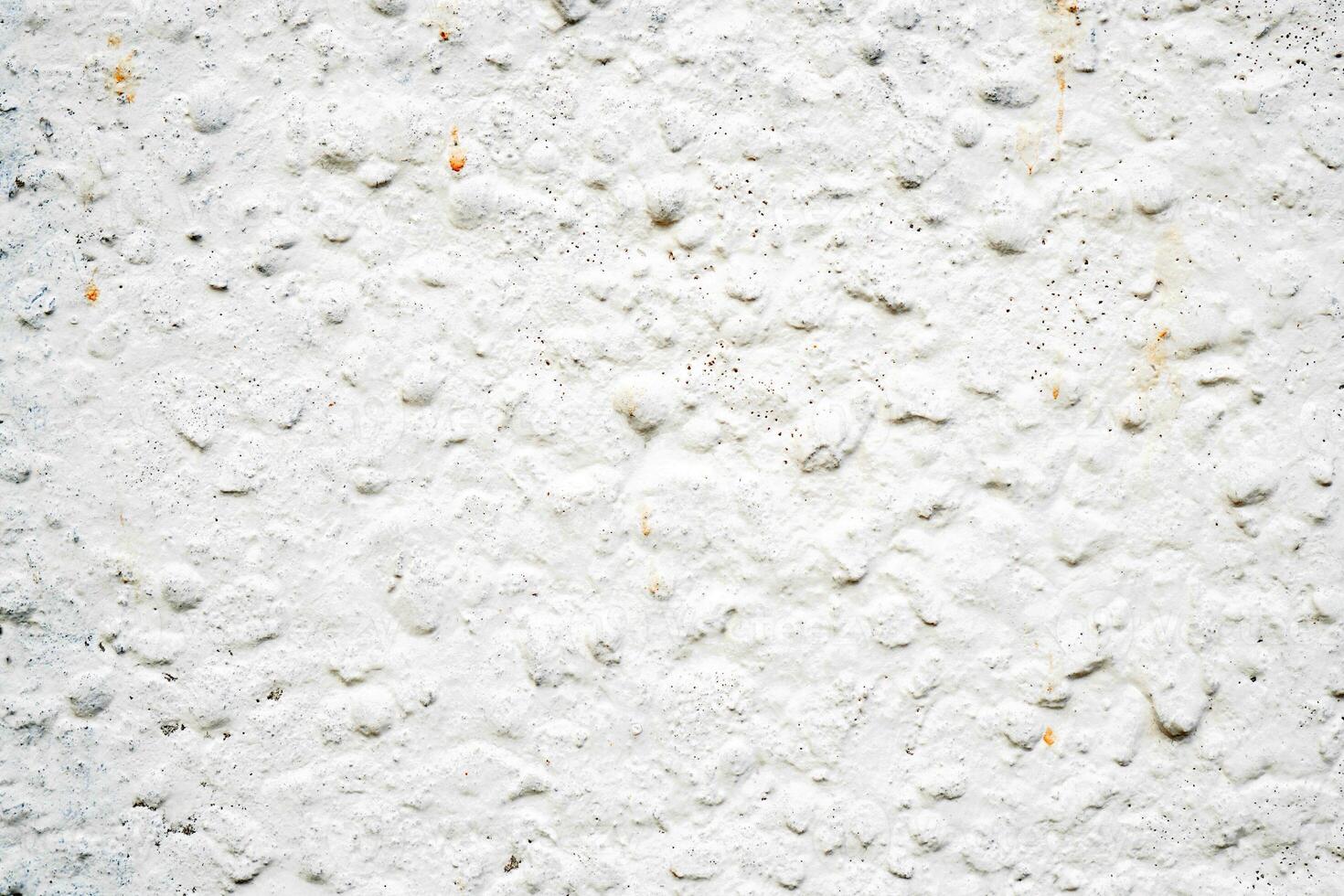 White texture of uneven plaster covering the wall. Building background. photo