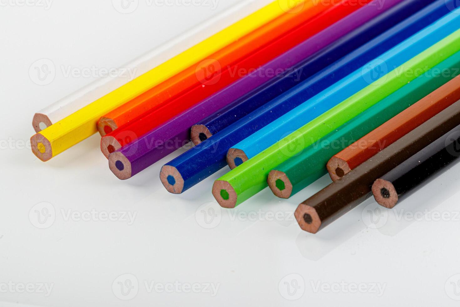 macro multicolored pencils on a white background photo