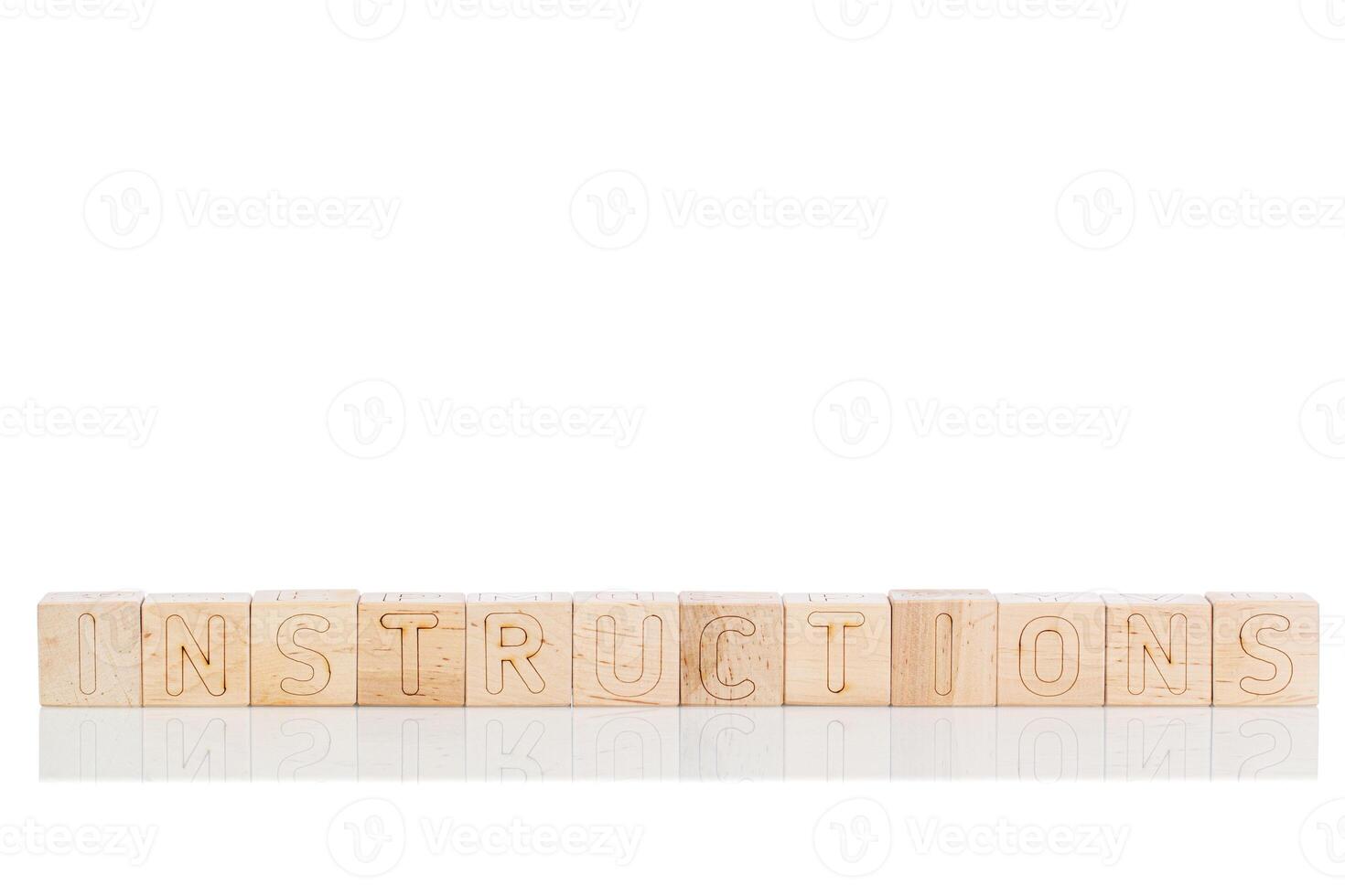 Wooden cubes with letters instructions on a white background photo