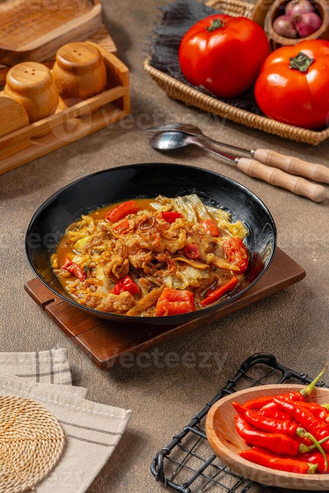Tongseng is beef stew dish in curry-like soup, with vegetables and sweet soy sauce photo