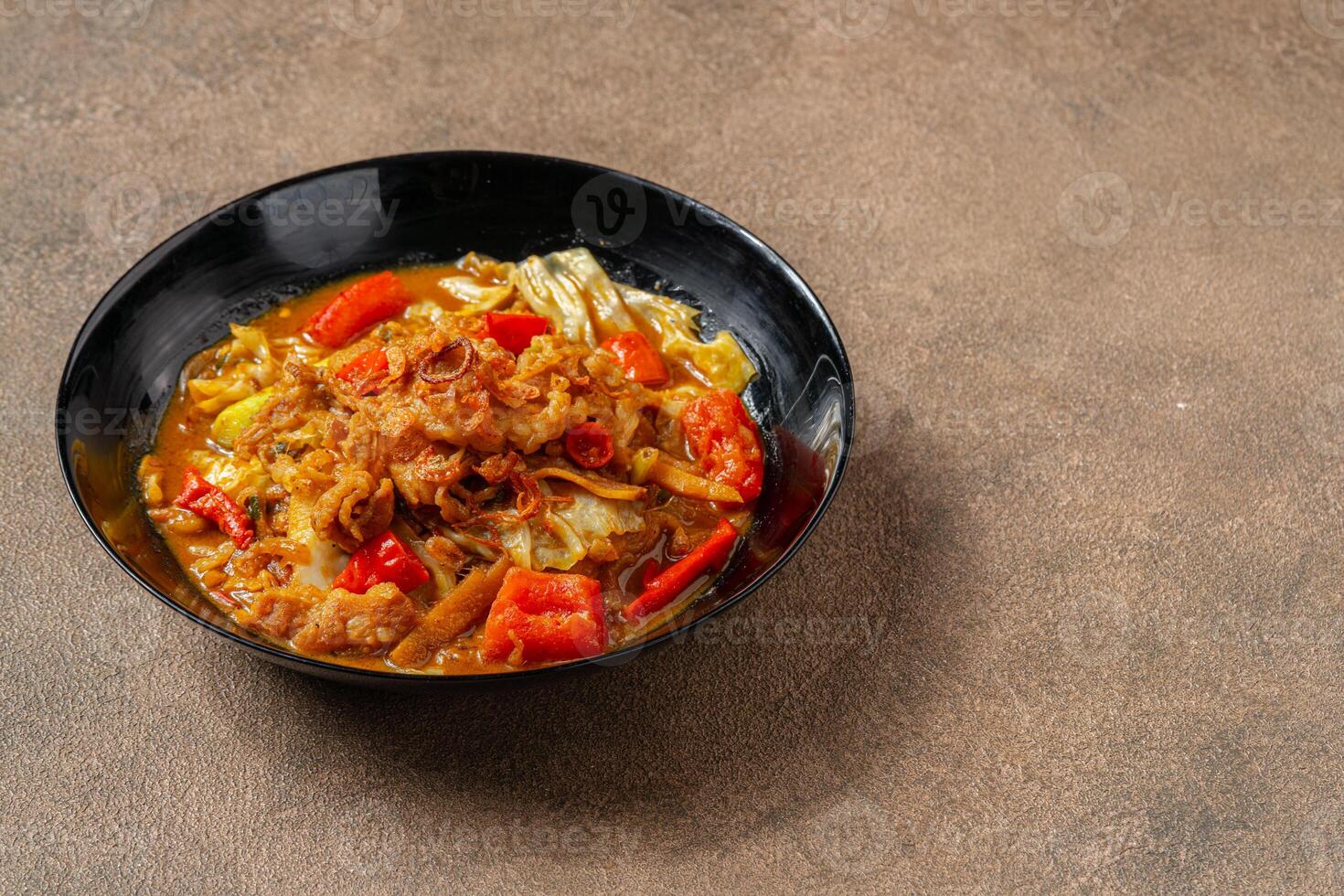 Tongseng is beef stew dish in curry-like soup, with vegetables and sweet soy sauce photo