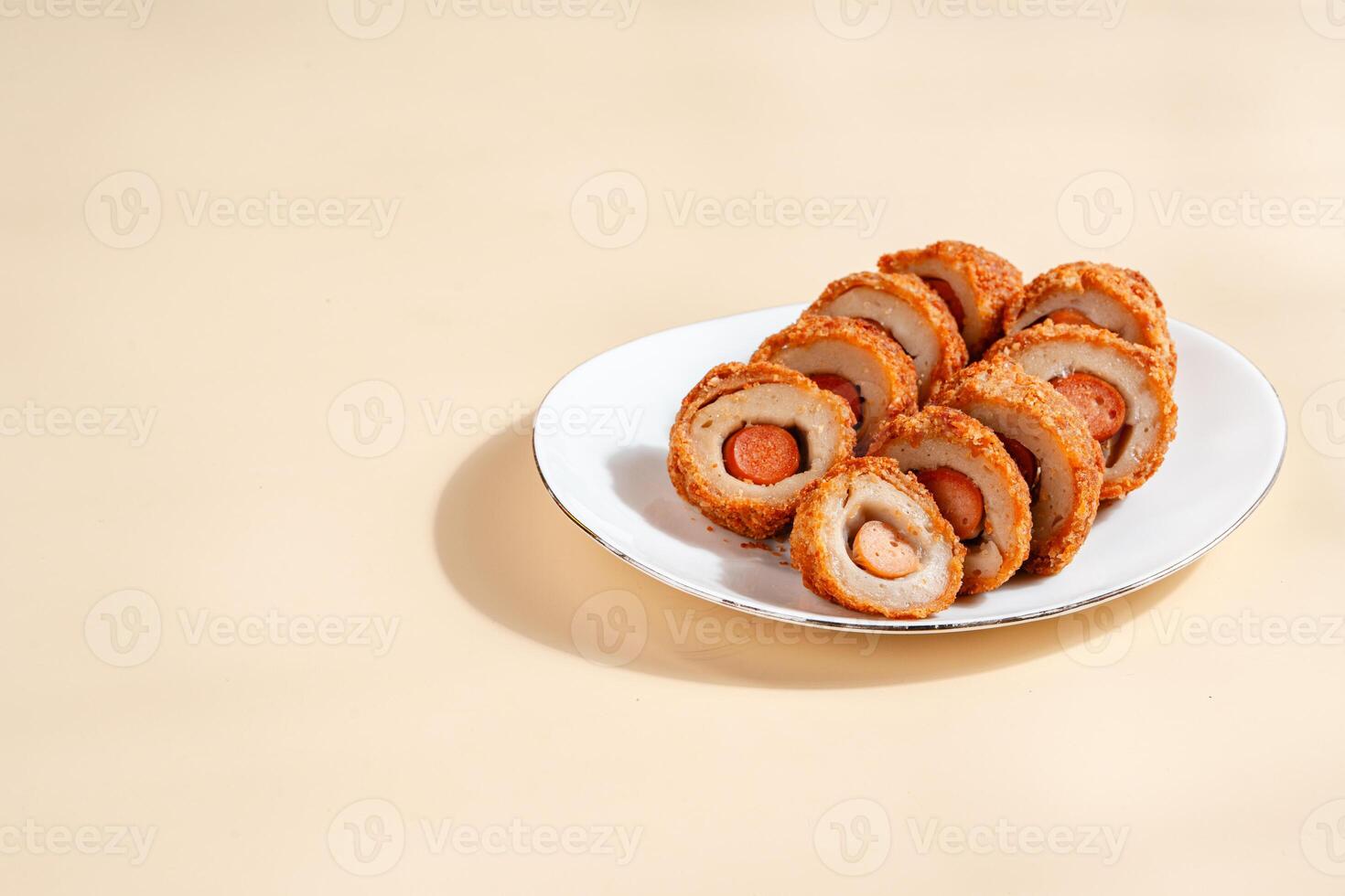 Pempek is a savoury Indonesian fishcake delicacy, made of fish and tapioca from Palembang. Pempek is served with sweet and sour sauce. photo