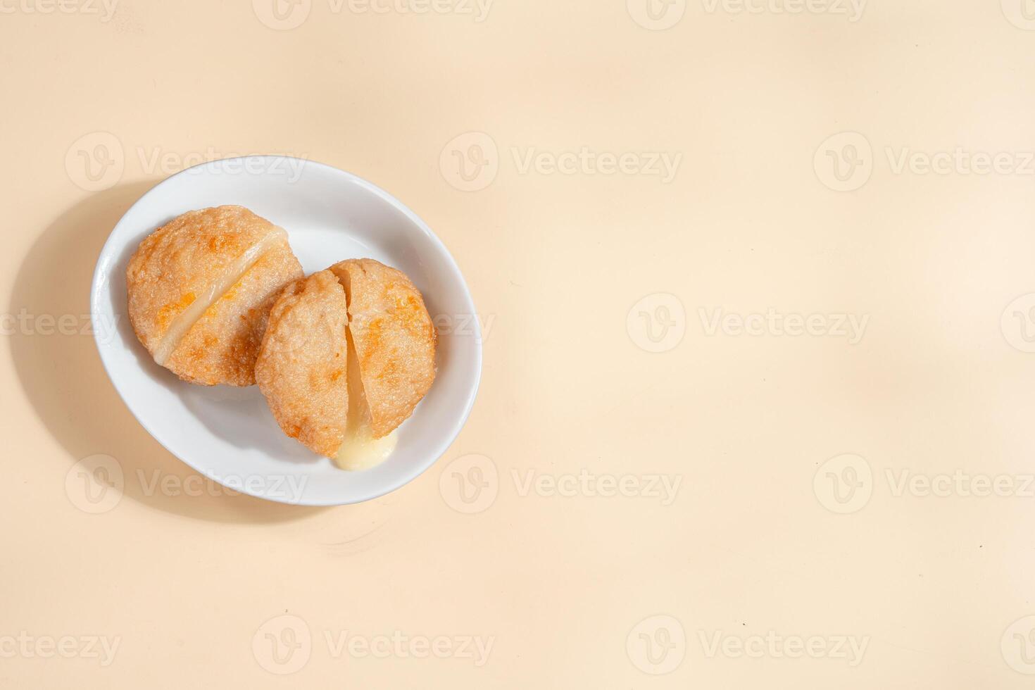 Pempek is a savoury Indonesian fishcake delicacy, made of fish and tapioca from Palembang. Pempek is served with sweet and sour sauce. photo