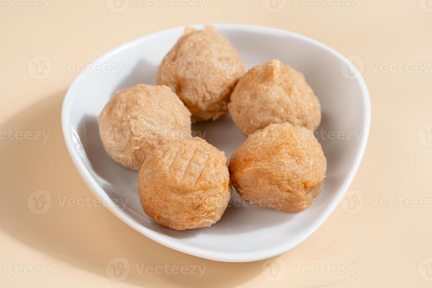 Pempek is a savoury Indonesian fishcake delicacy, made of fish and tapioca from Palembang. Pempek is served with sweet and sour sauce. photo