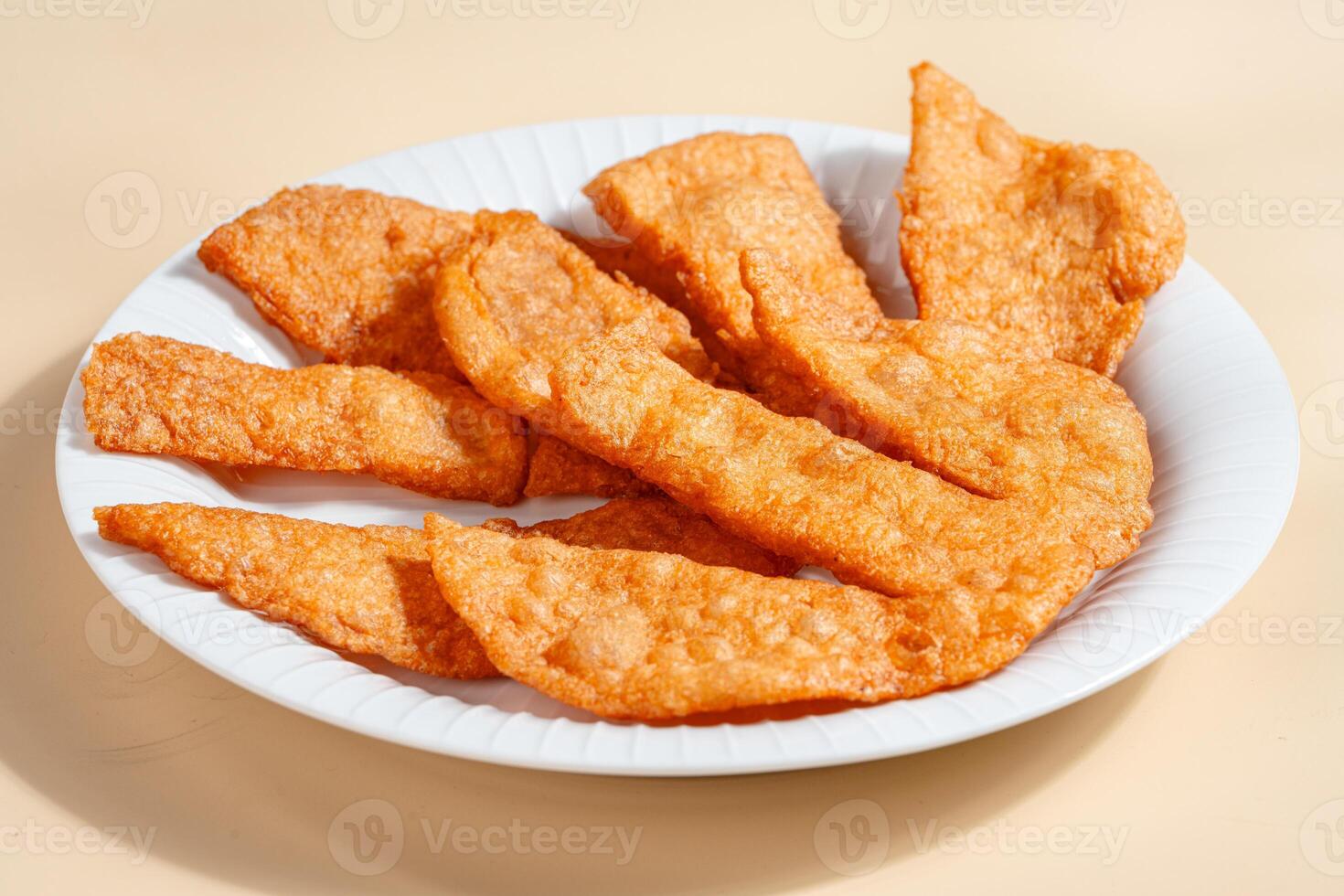 Pempek is a savoury Indonesian fishcake delicacy, made of fish and tapioca from Palembang. Pempek is served with sweet and sour sauce. photo