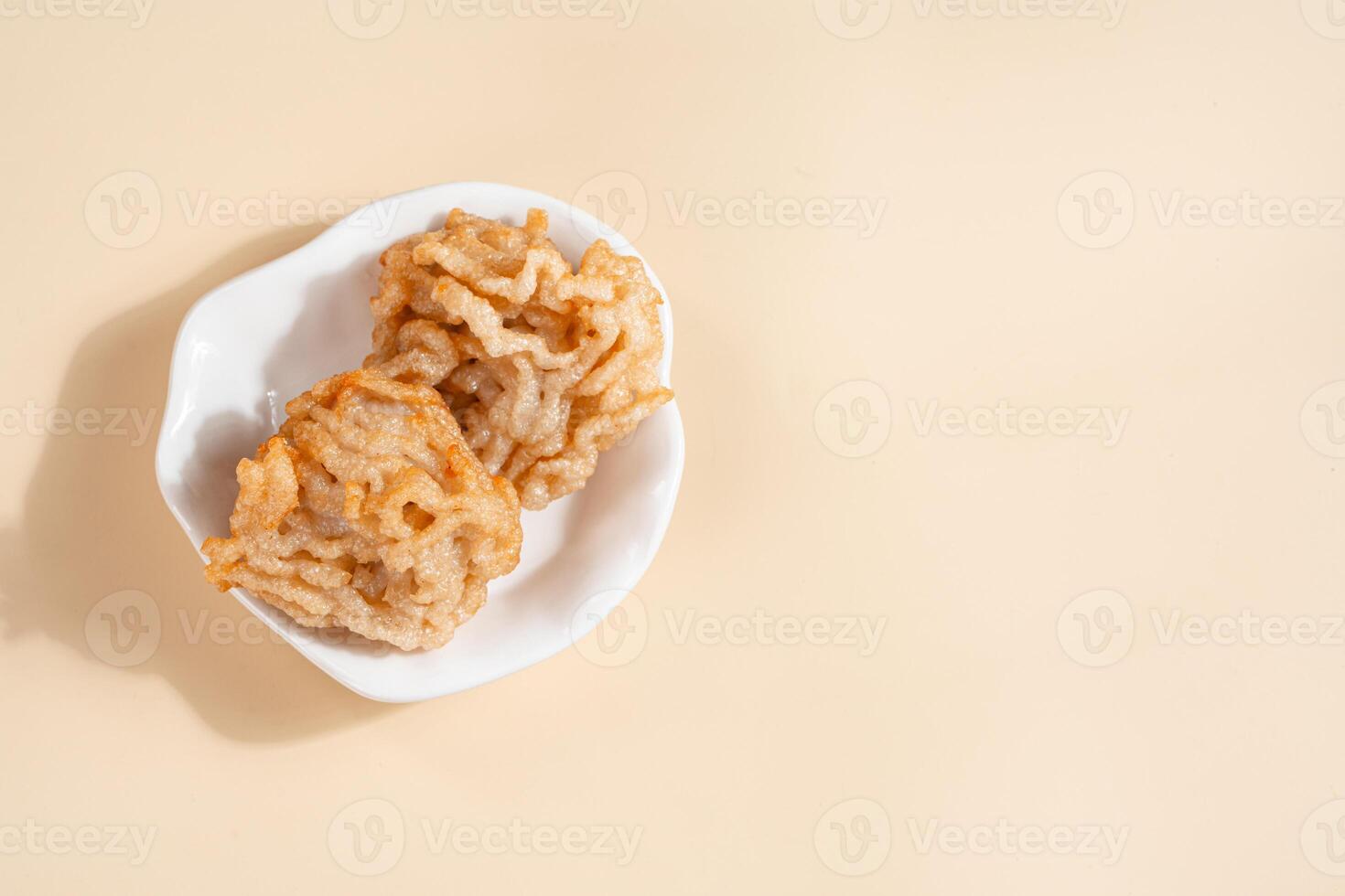 Pempek is a savoury Indonesian fishcake delicacy, made of fish and tapioca from Palembang. Pempek is served with sweet and sour sauce. photo