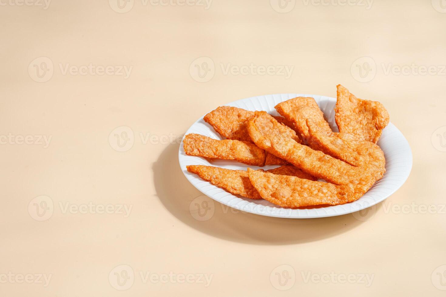 Pempek is a savoury Indonesian fishcake delicacy, made of fish and tapioca from Palembang. Pempek is served with sweet and sour sauce. photo