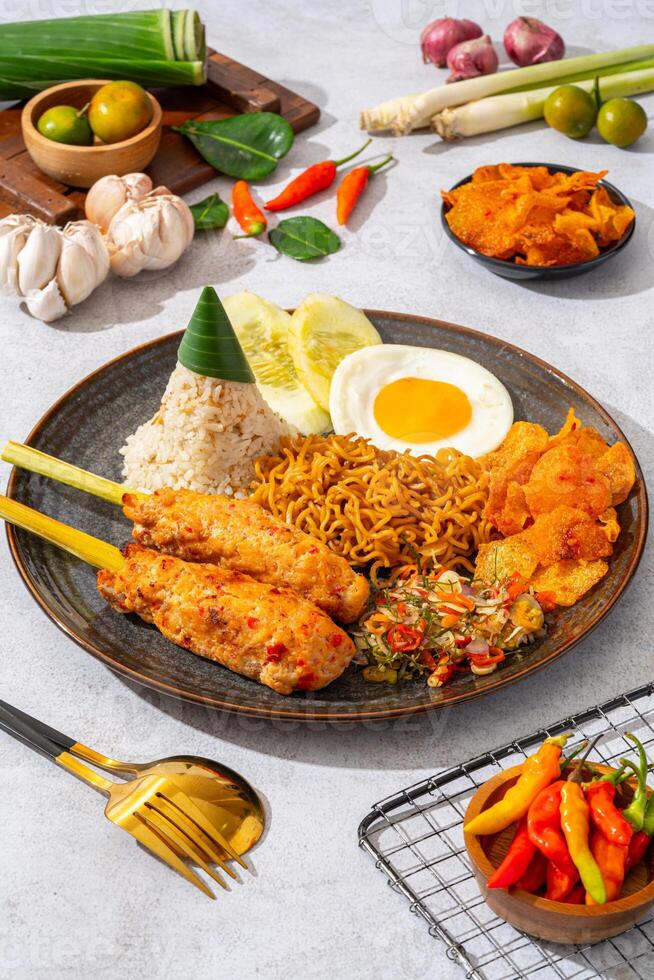 sate lilit is a satay variant in Indonesia, originating from Balinese cuisine. This satay is made from minced chicken and spiced minced meat is wound around lemongrass sticks then grilled on charcoal photo
