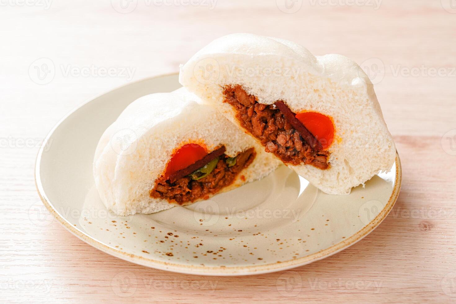 Baozi or Bakpao is a type of yeast-leavened filled bun in various Chinese cuisines. photo