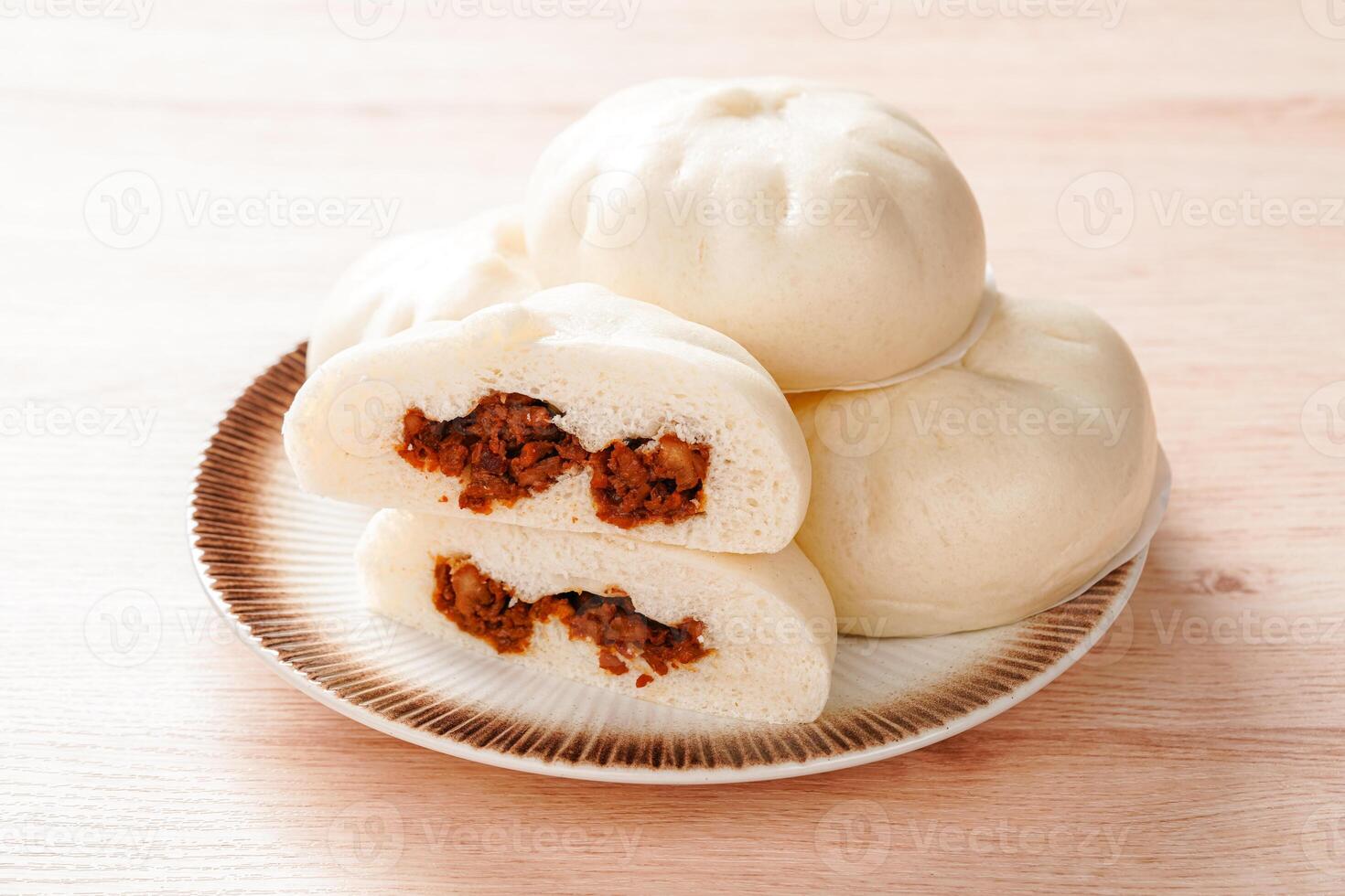 Baozi or Bakpao is a type of yeast-leavened filled bun in various Chinese cuisines. photo