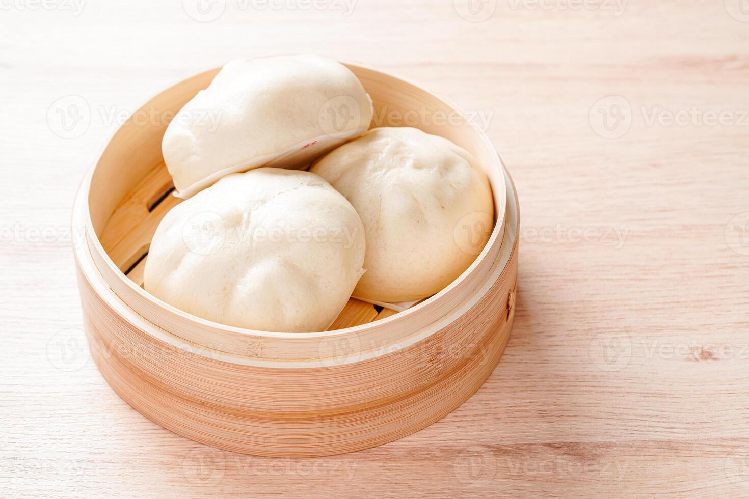 Baozi or Bakpao is a type of yeast-leavened filled bun in various Chinese cuisines. photo