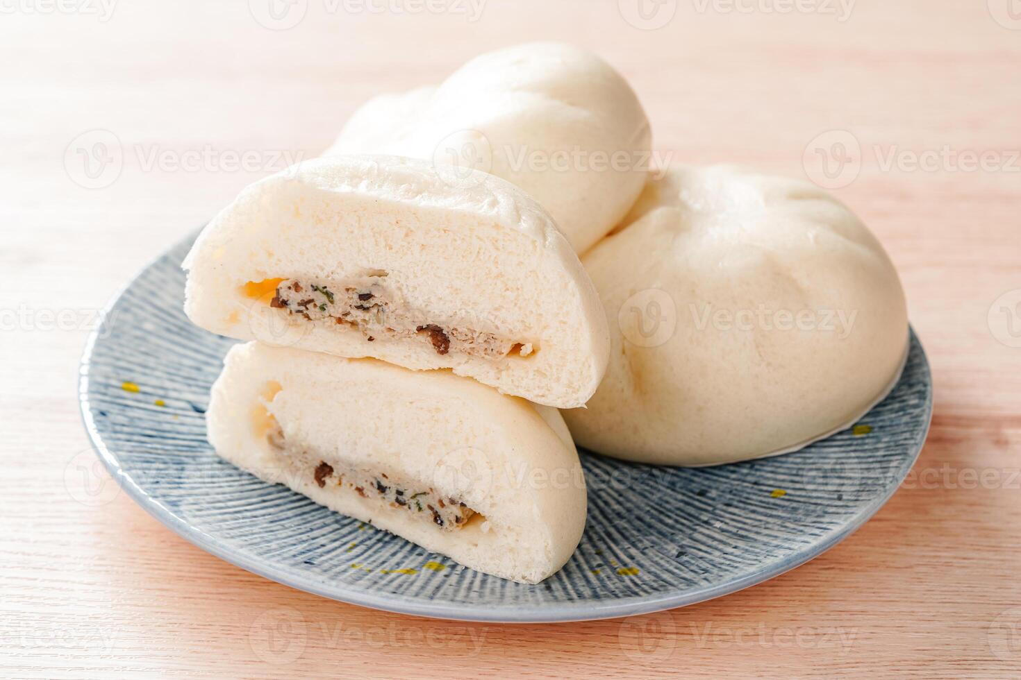 Baozi or Bakpao is a type of yeast-leavened filled bun in various Chinese cuisines. photo