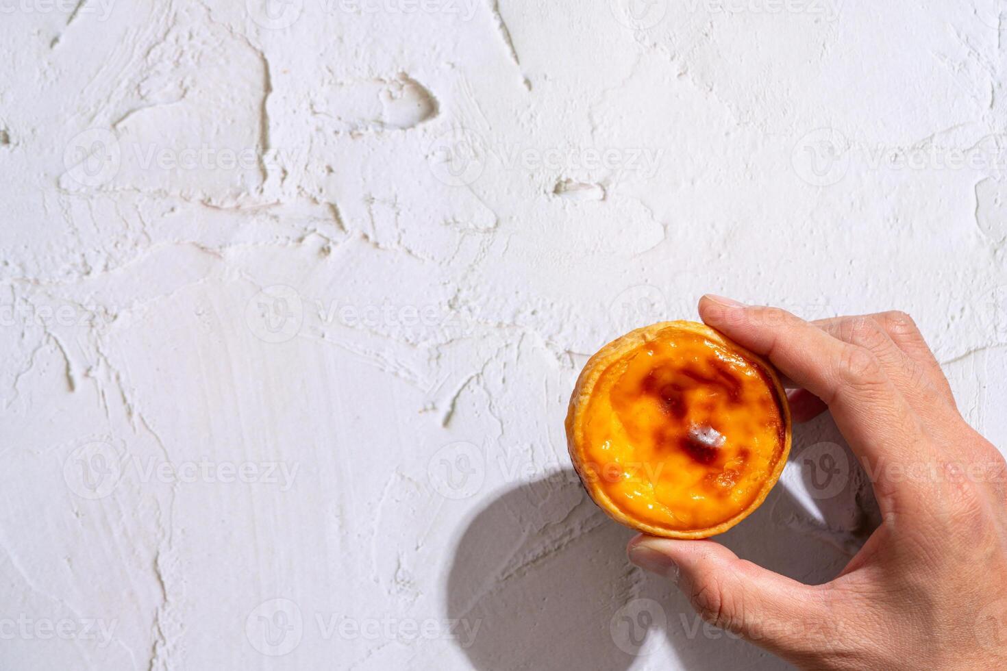 Egg tart, traditional Portuguese dessert, pastel de nata. Pasteis de Belem is a Portuguese egg custard tart pastry dusted with cinnamon. photo