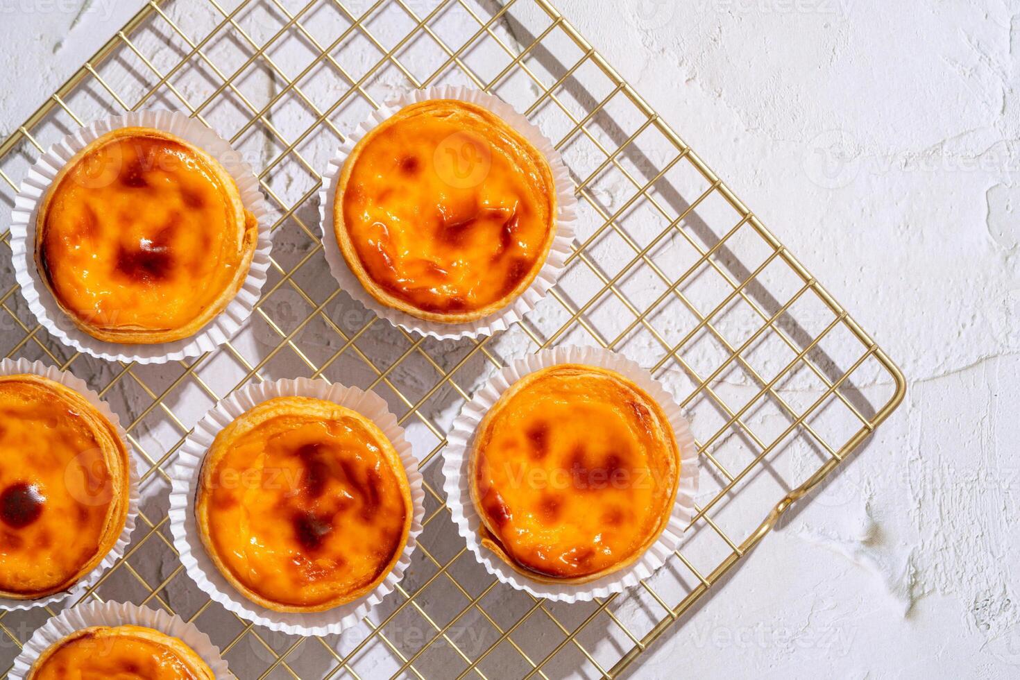Egg tart, traditional Portuguese dessert, pastel de nata. Pasteis de Belem is a Portuguese egg custard tart pastry dusted with cinnamon. photo