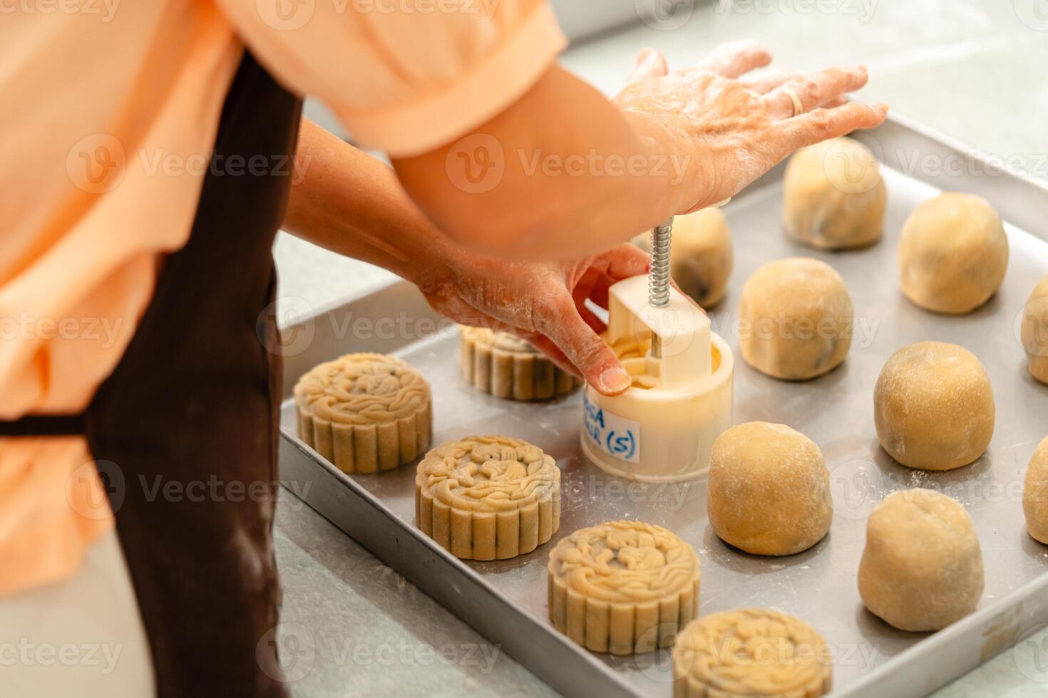 Mooncake making process. A mooncake is a Chinese bakery product traditionally eaten during the Mid Autumn Festival. photo