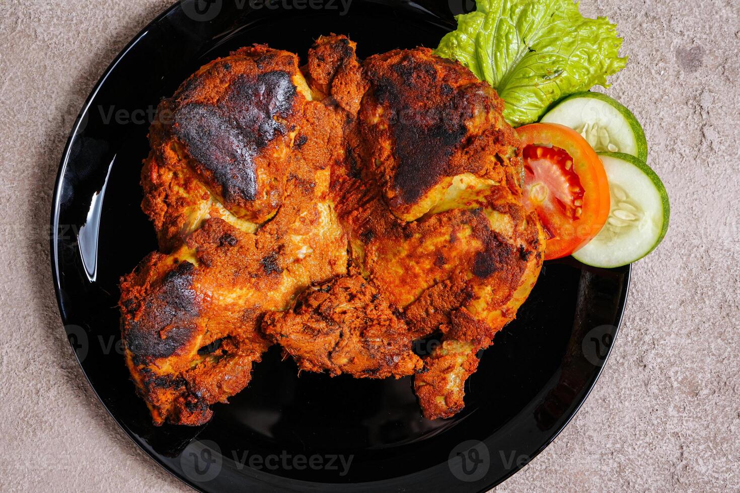 Ayam bakar is a indonesian dish, Ayam bakar literally means roasted chicken, in the smoky burning process. photo
