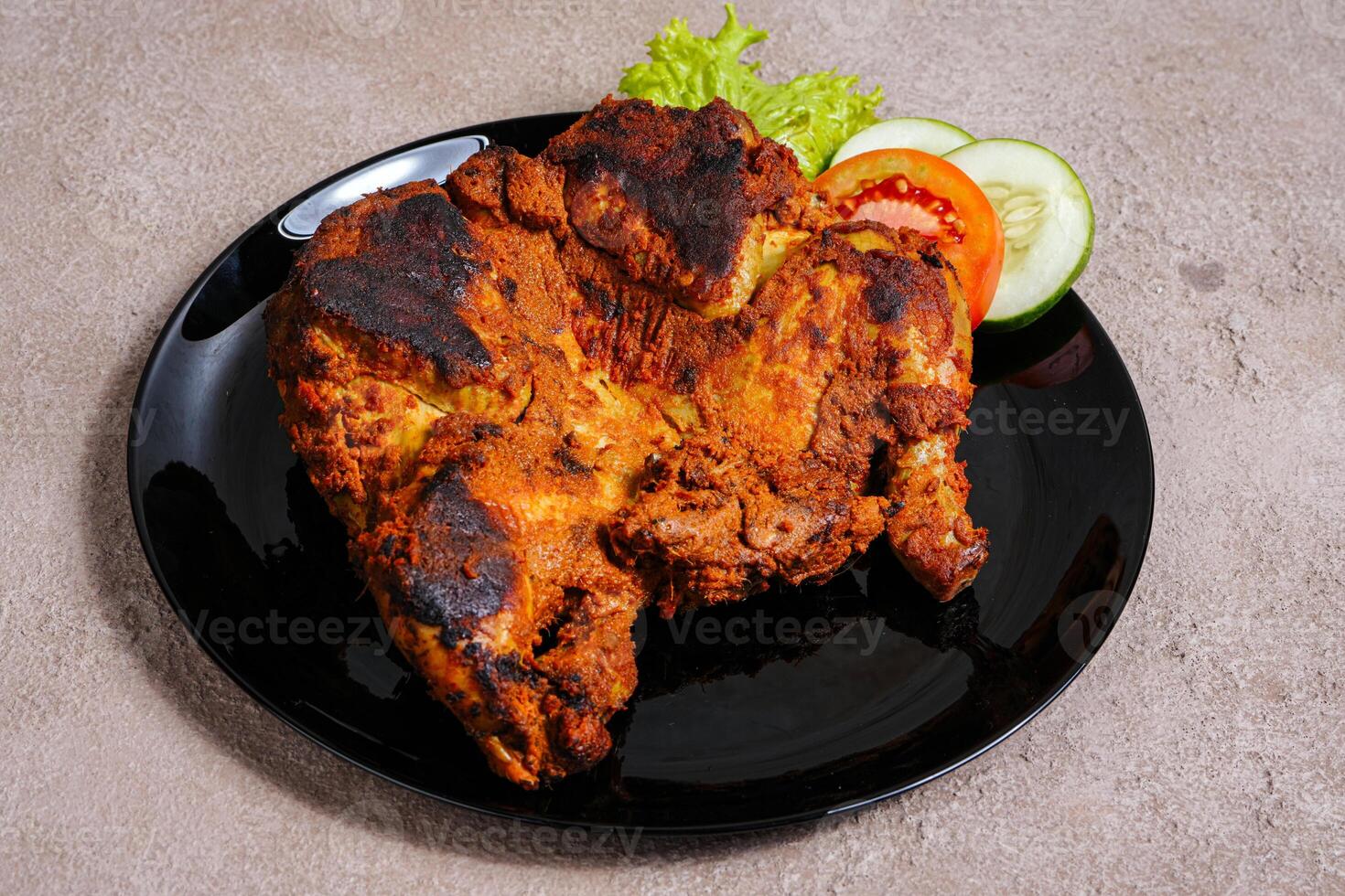 Ayam bakar is a indonesian dish, Ayam bakar literally means roasted chicken, in the smoky burning process. photo