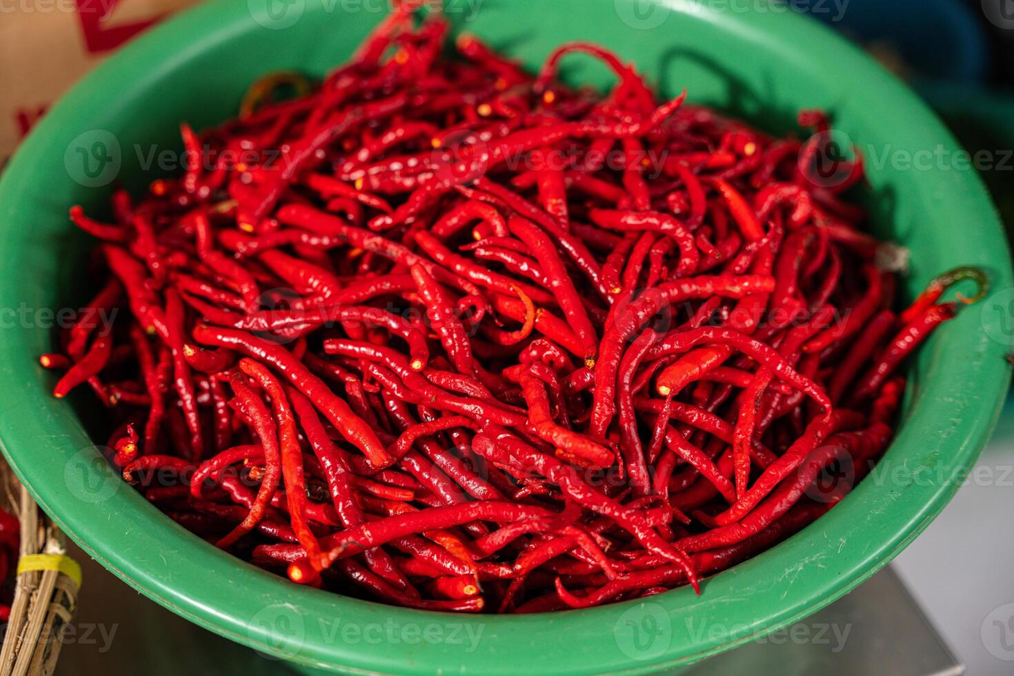 pile of Fresh Chilies and Ripe Red Chilies in Baskets for Sale at the Vegetable Market photo
