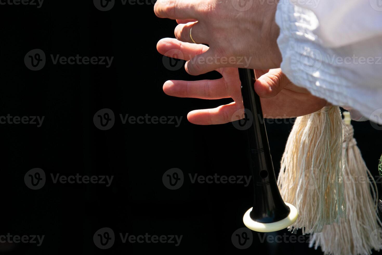 fingers of a bagpipe player playing the bagpipes in Galicia, folk music concept photo