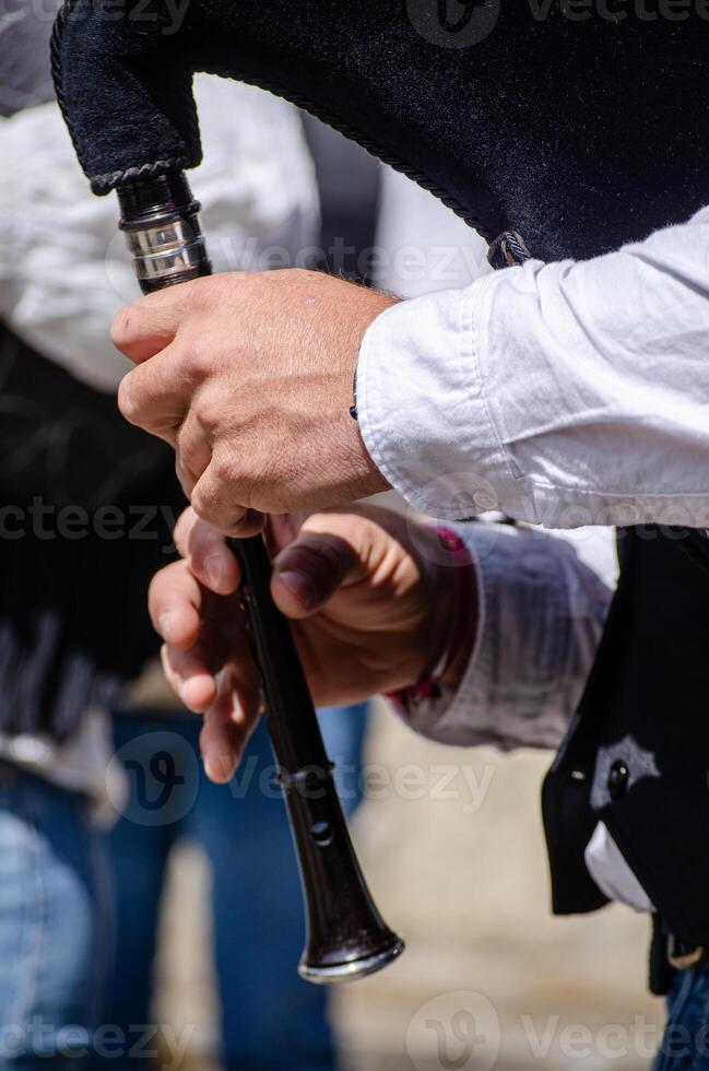 hands of a bagpiper playing his instrument, music concept photo