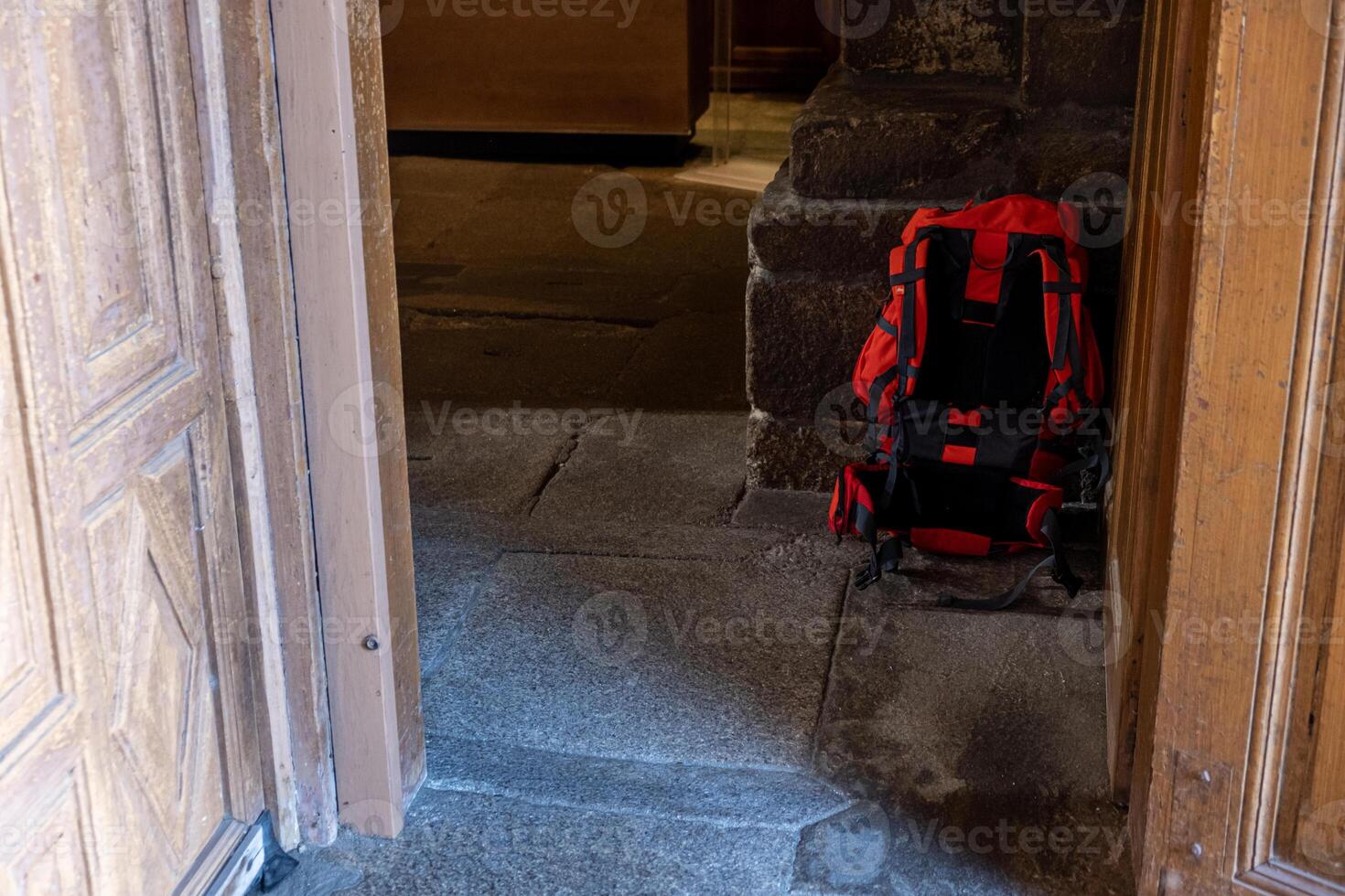 backpack of a pilgrim in a church on the Way of St. James, peregrination concept photo