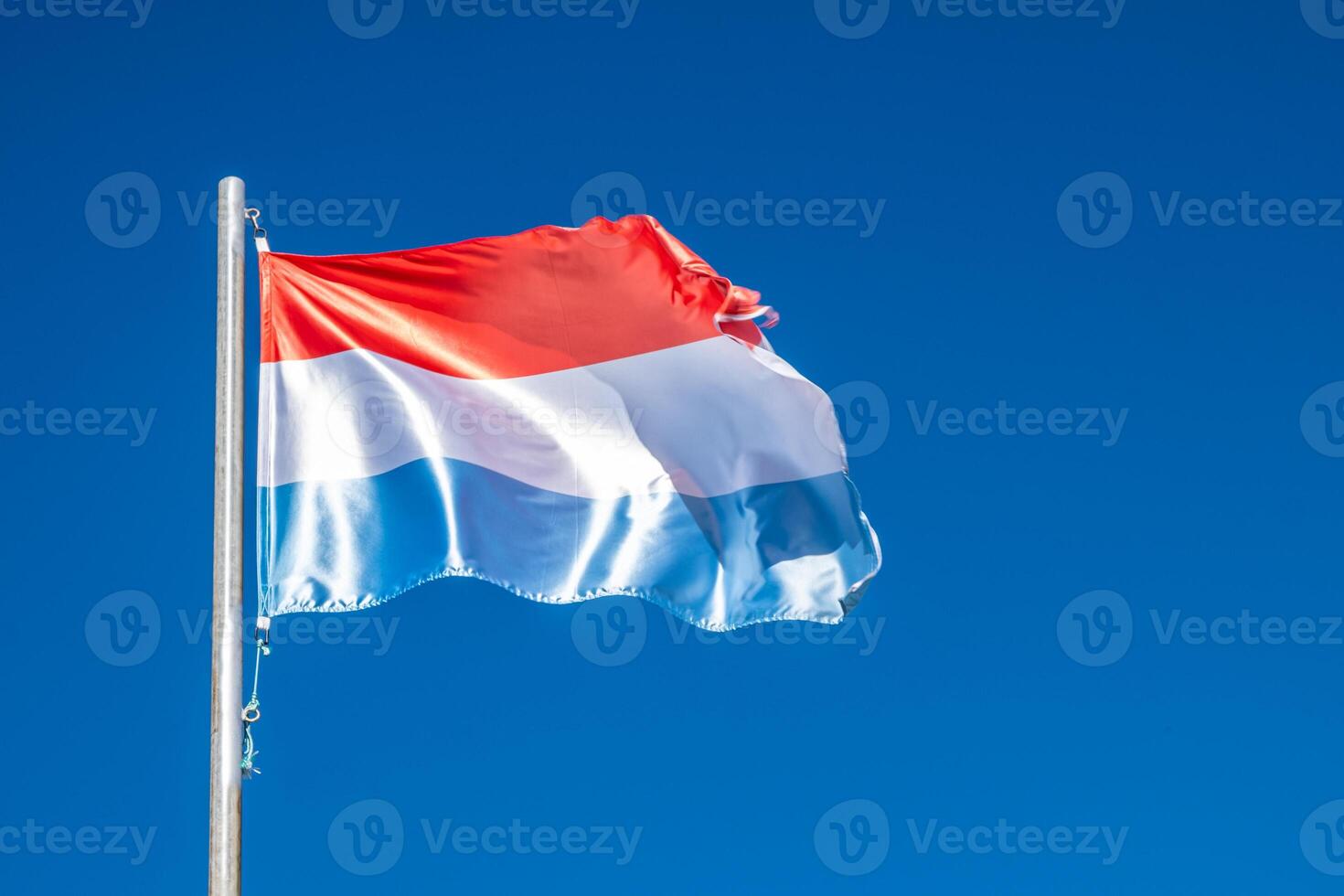 a flag of Holland fluttering in the wind photo