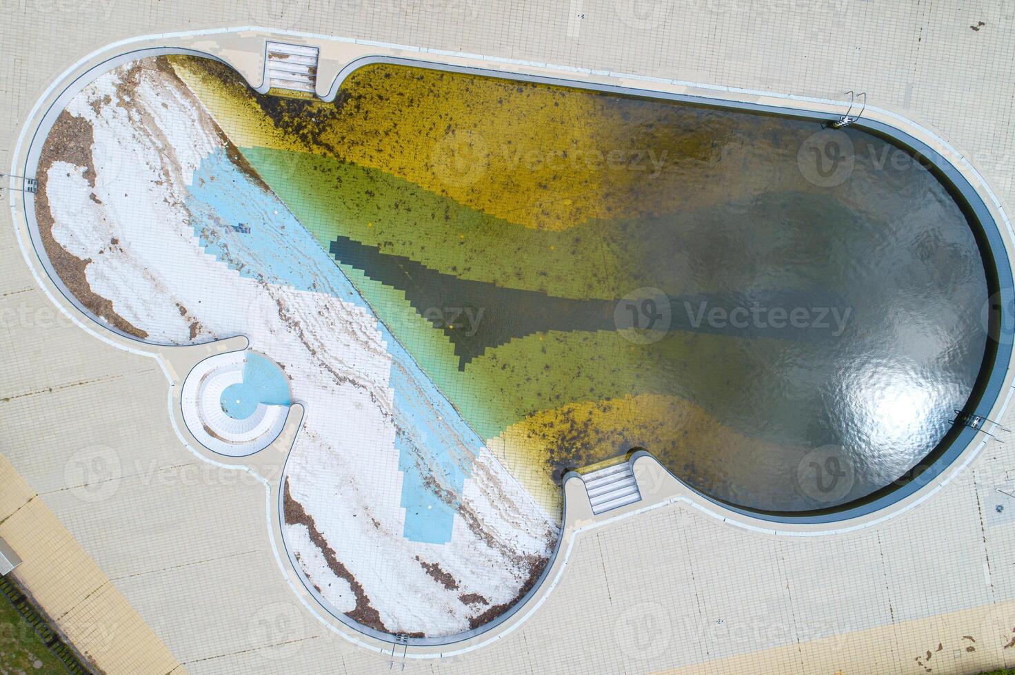 aerial top view of a pool with dirty water due to abandonment photo