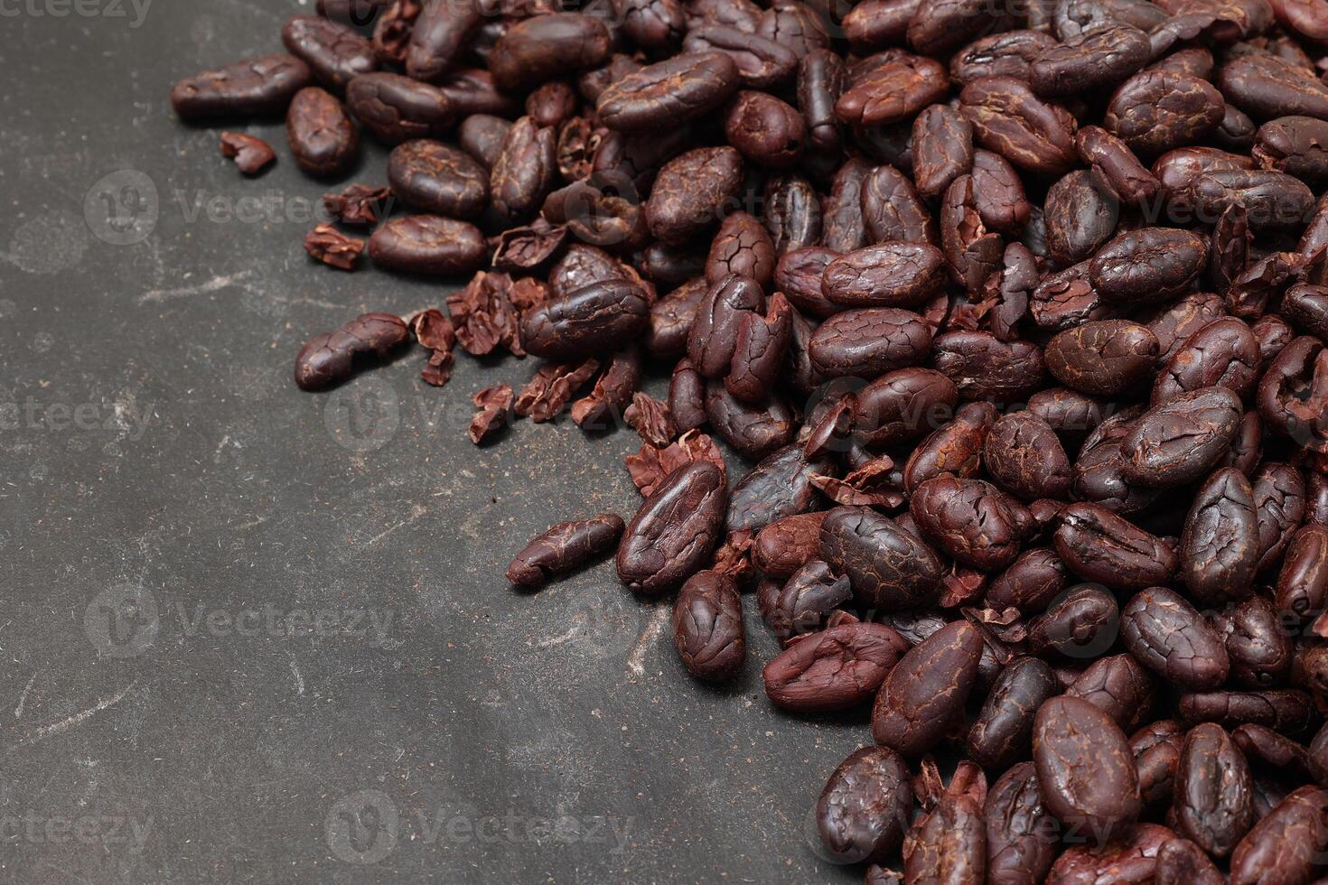 Cocoa beans on black table background photo