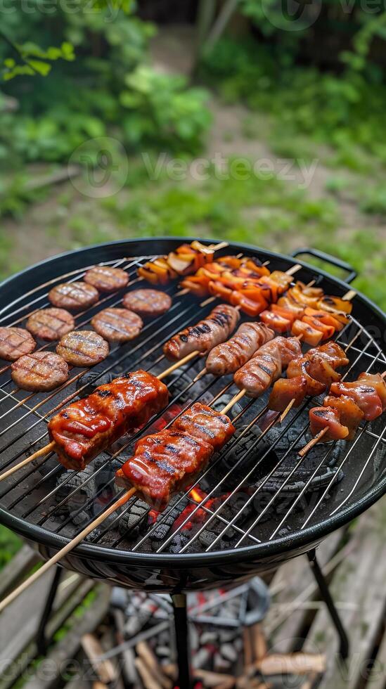 Variety of skewers and sausages grilling on a charcoal barbecue photo
