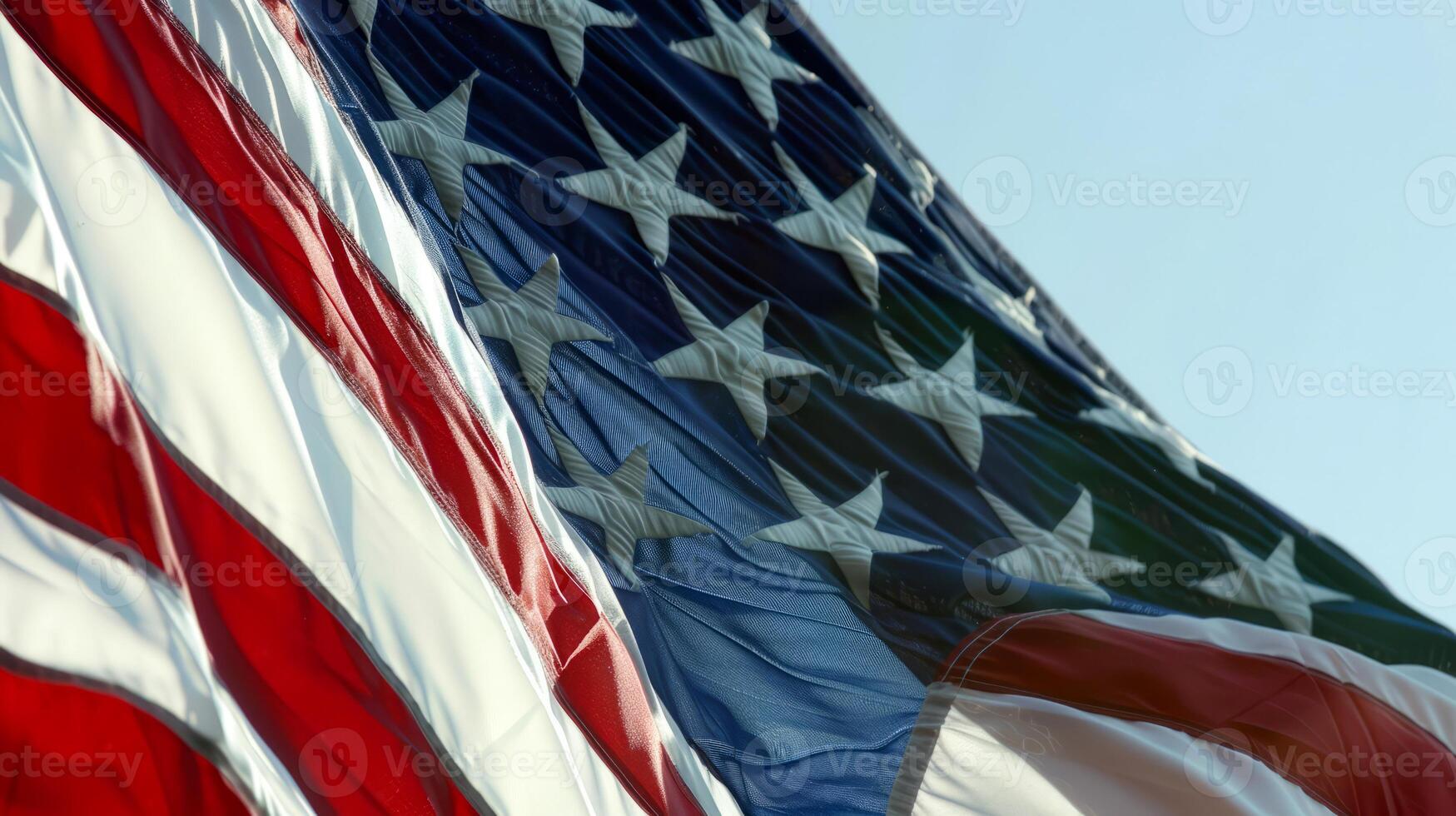 Close-up of American Flag Waving Against Clear Blue Sky photo