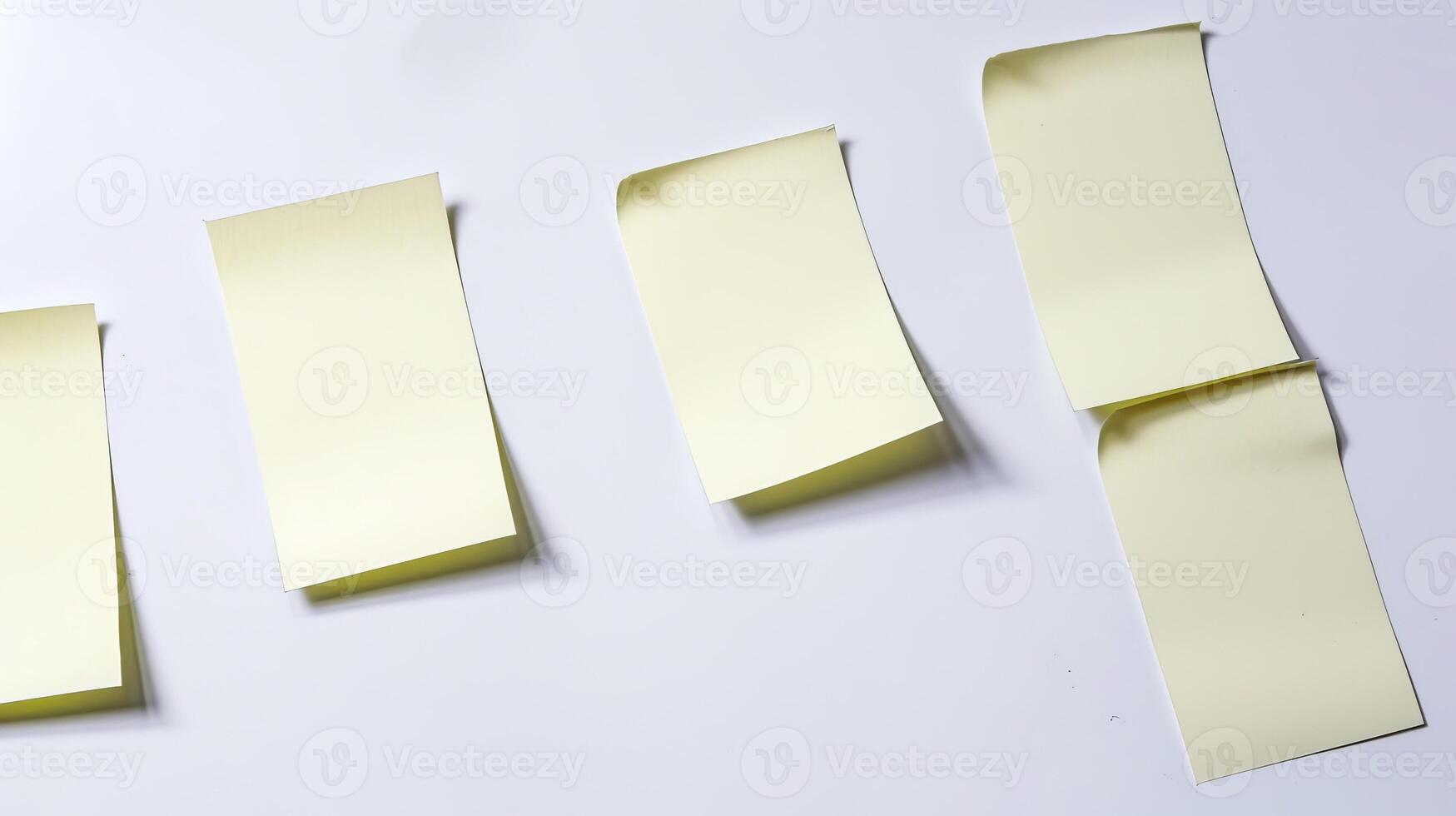 Four sticky notes on a white background, organized and slightly curled photo