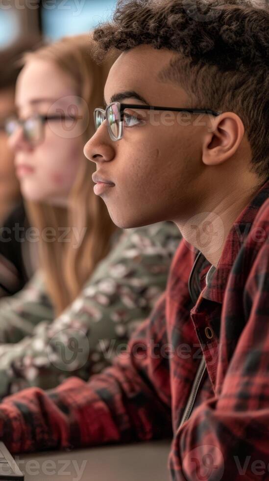 Teenagers engaged in computer lab for technology class photo