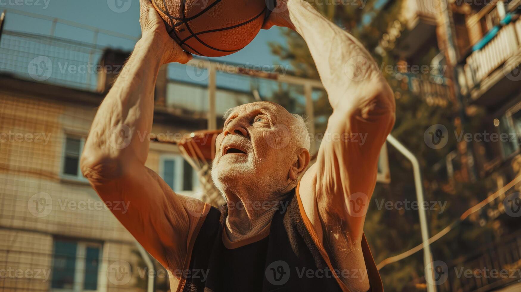 Senior man shooting basketball outdoors in urban setting photo