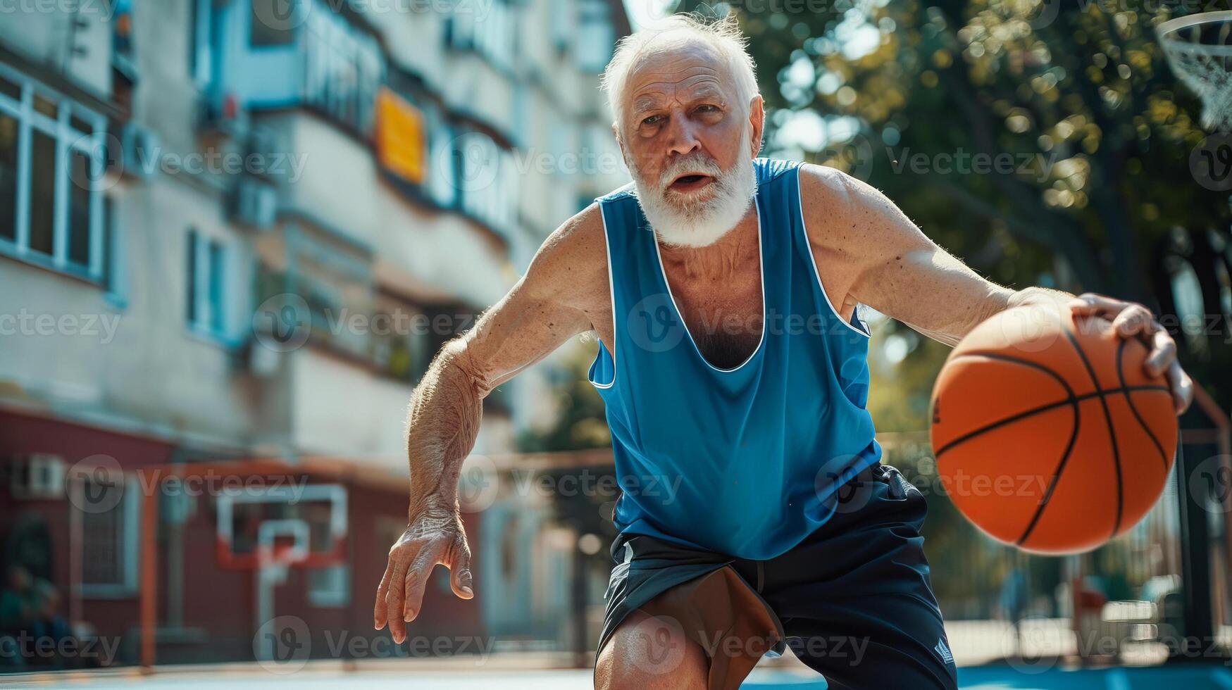 Elderly man playing basketball with determination on outdoor court photo