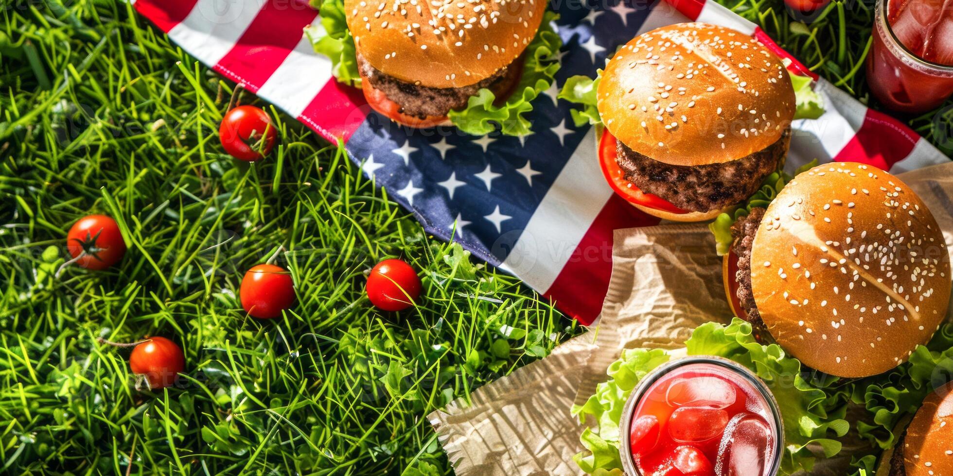 Delicious burgers and cold drinks on grass with USA flag photo